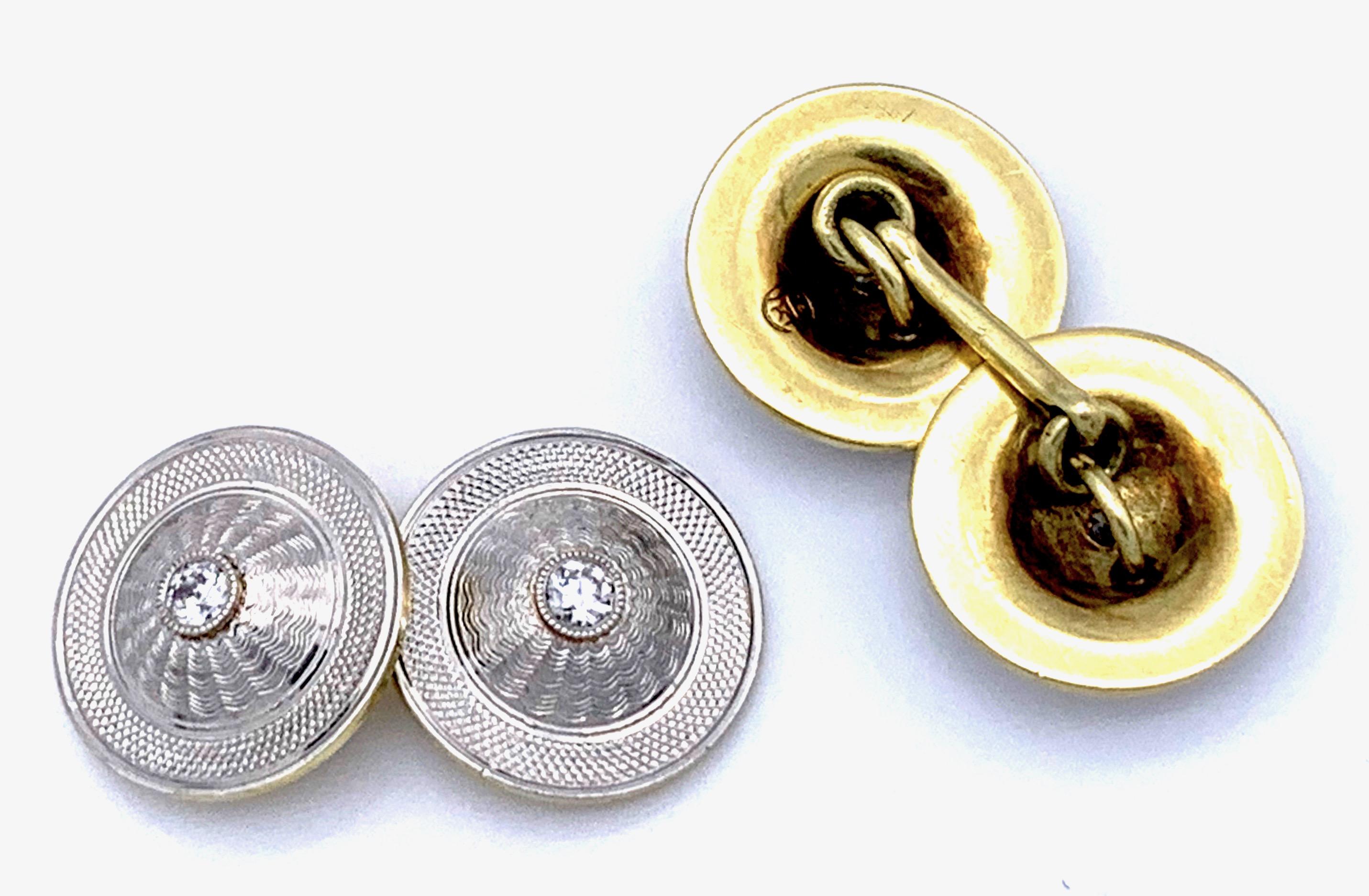 These very attractive and elegant cufflinks are designed as round,  gold backed platinum elements with two different kinds of engravings. 
The reverse of the links have engraved the ligated letters C and H and the number 14.  Each disk is