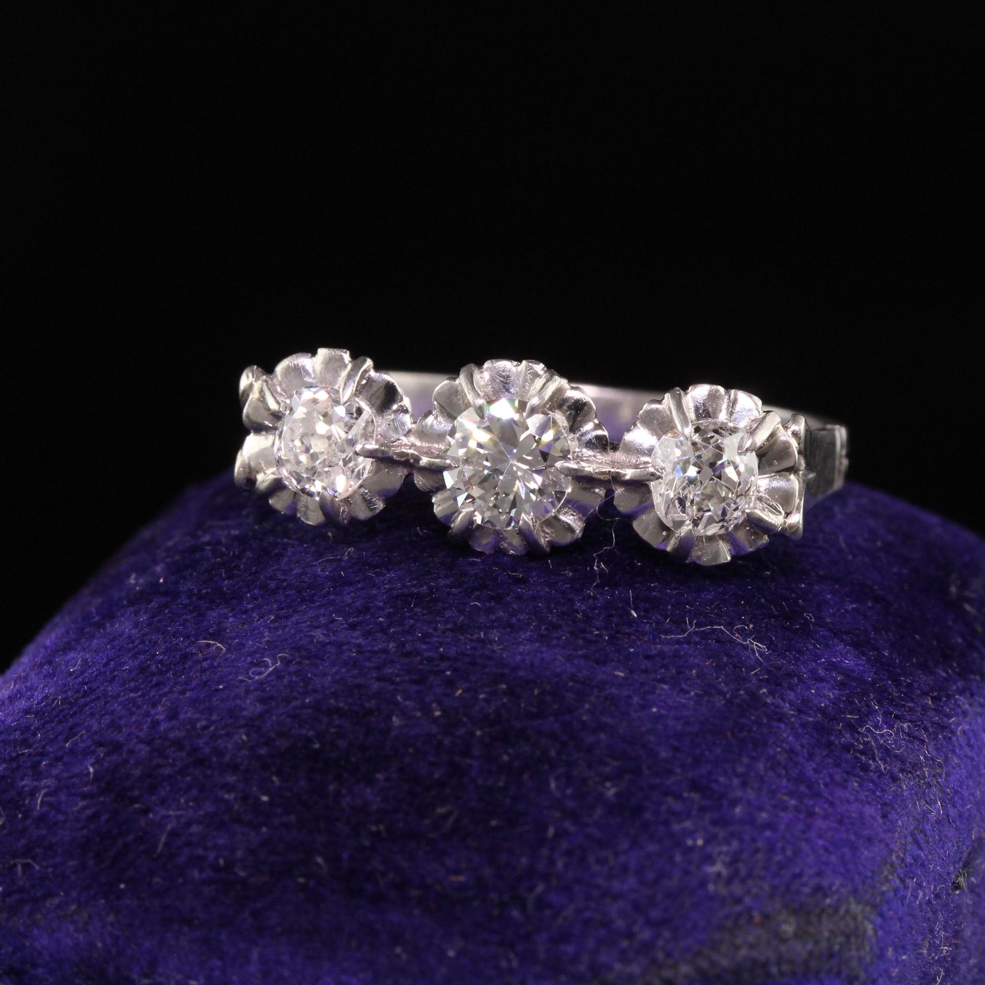 Beautiful Antique Art Deco Platinum Hallmarked Old Mine Diamond Three Stone Ring. This gorgeous three stone ring is crafted in platinum. It has three old mine cut diamonds set on the top and has two hallmarks outside of the shank which appear to be