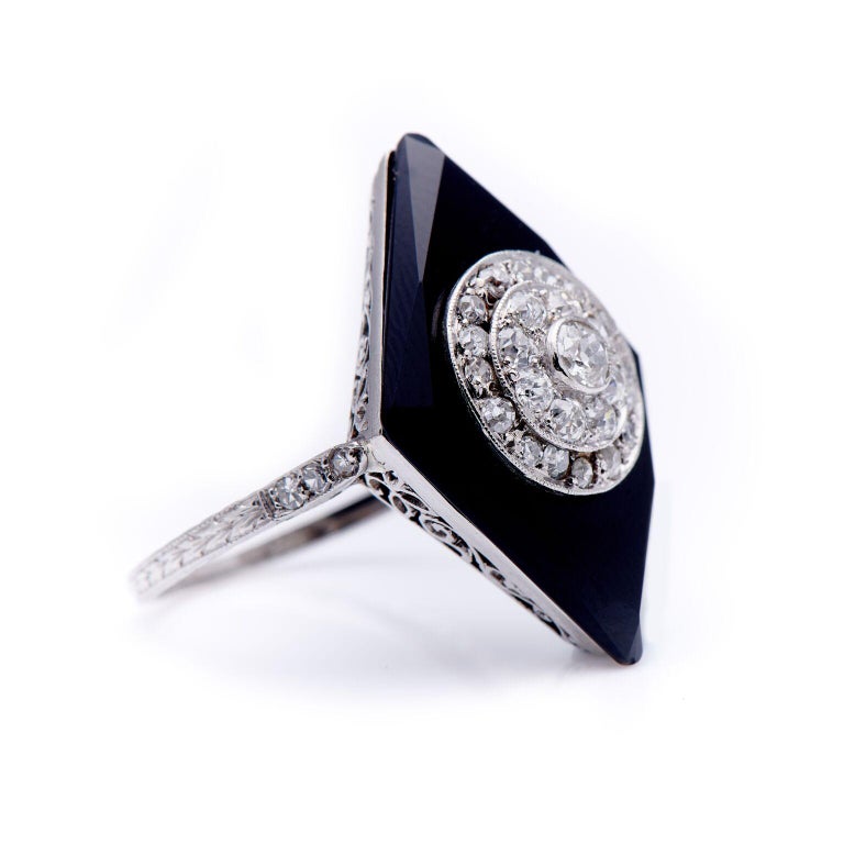 Art Deco, onyx and diamond cocktail ring, circa 1920. A wonderful kite-shaped onyx features a double row cluster of old-cut diamonds, all set in platinum. The ring is beautifully made, the attention to detail exquisite; the gallery (underneath