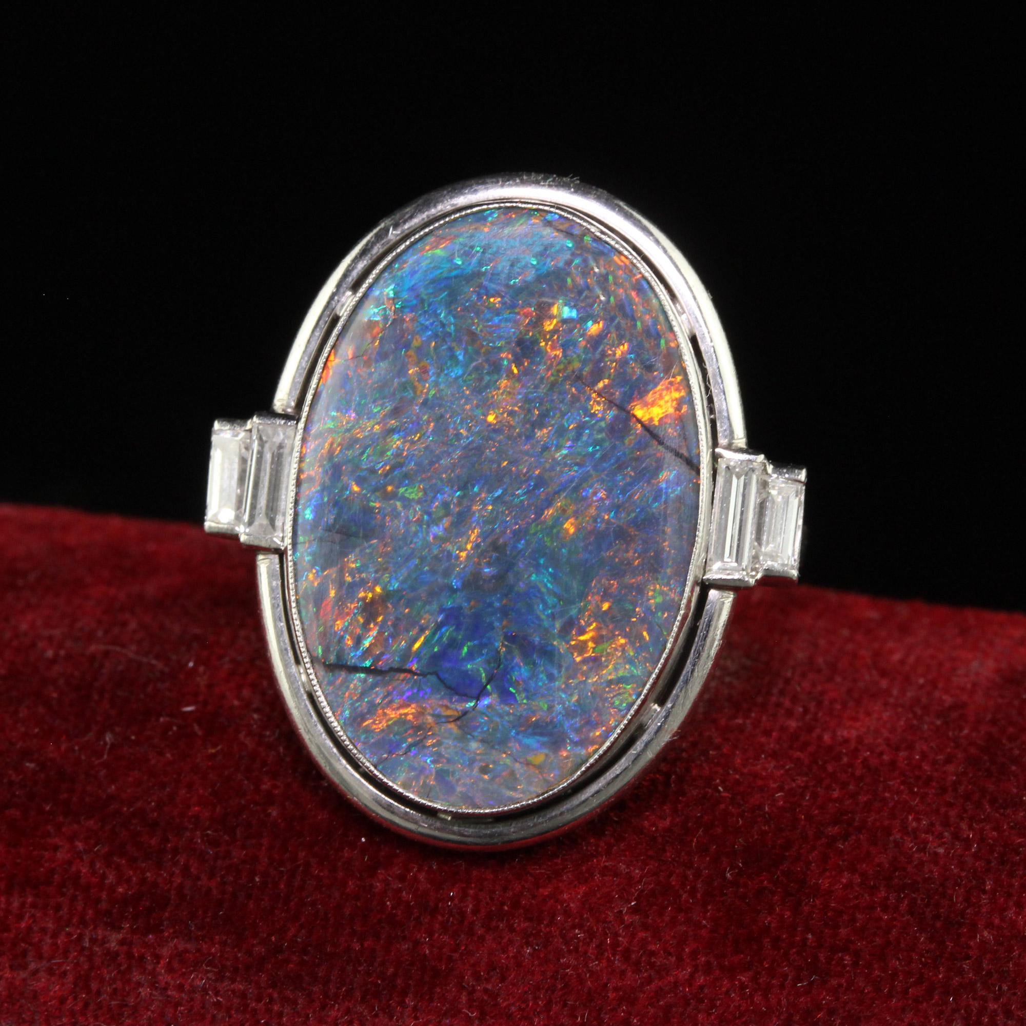 Beautiful Antique Art Deco Platinum Natural Black Opal and Diamond Statement Ring - GIA. This gorgeous art deco black opal ring is crafted in platinum. The center of this gorgeous ring holds a natural black opal that has an incredible array of