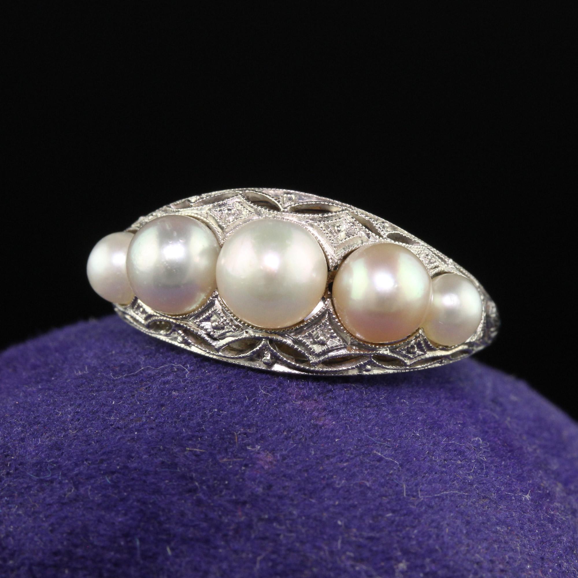 Beautiful Antique Art Deco Platinum Natural Pearl Five Stone Filigree Ring. This beautiful natural pearl ring is crafted in platinum. The top of the ring has five graduated pearls on it and they are set in a beautiful Art Deco filigree mounting that