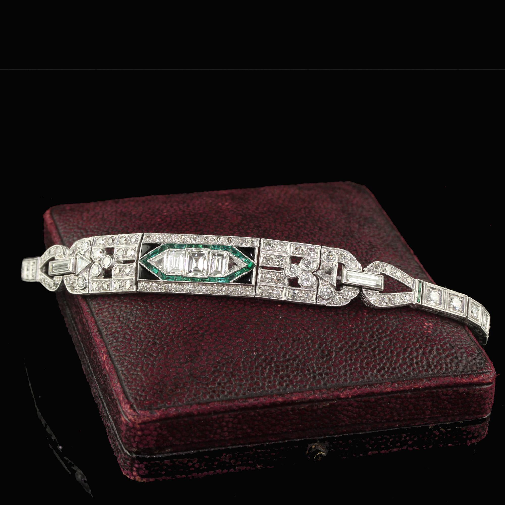 Beautiful Antique Art Deco Platinum Old Carre Cut Diamond Emerald Onyx Bracelet. This gorgeous Art Deco diamond bracelet is crafted in platinum. This bracelet features Old European, Carre, and Baguette cut diamonds set throughout the bracelet in a