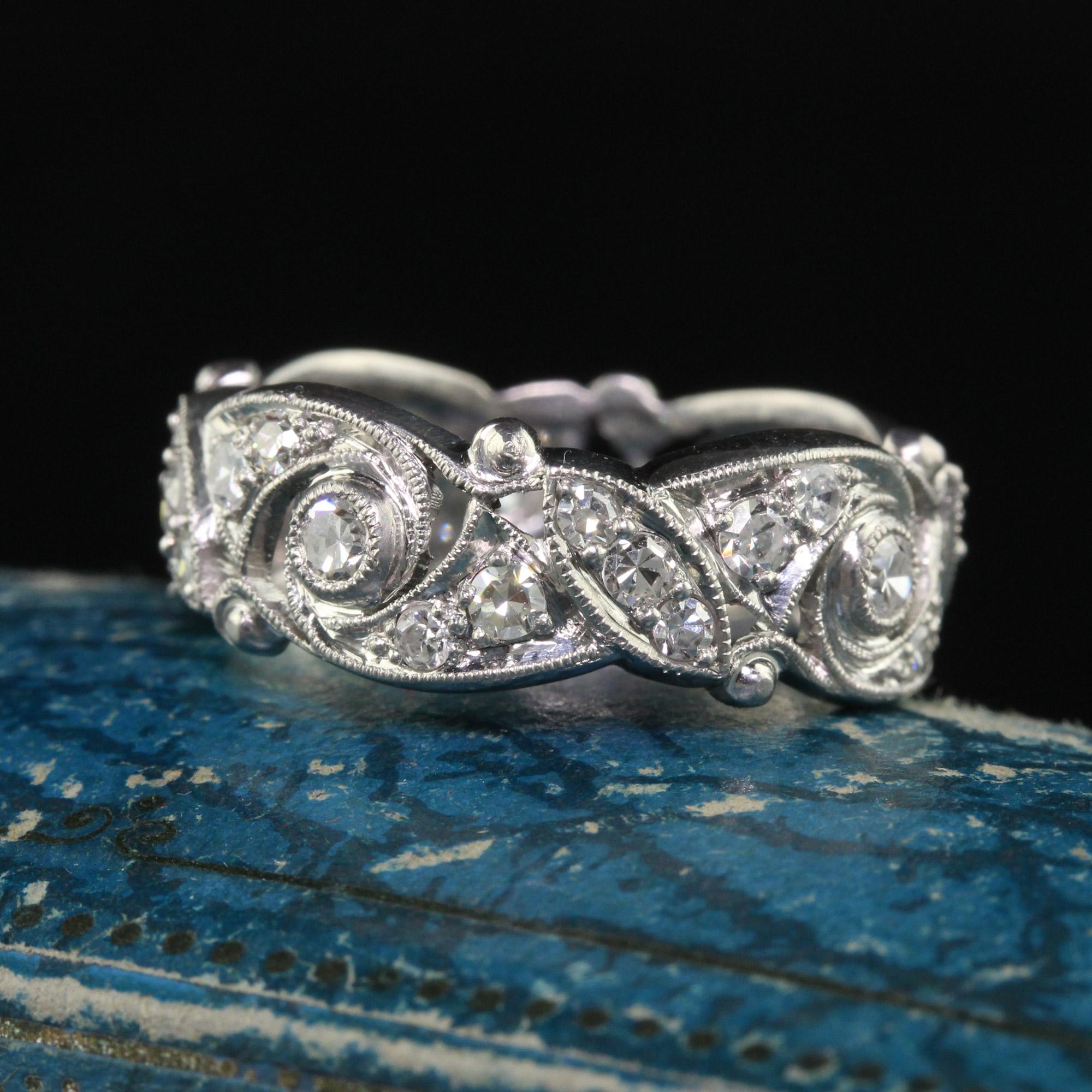 Beautiful Antique Art Deco Platinum Old Cut Diamond Floral Eternity Wedding Band. This gorgeous wedding band is crafted in platinum. The ring holds beautiful white old cut diamonds going around the entire ring. The ring has open filigree around the