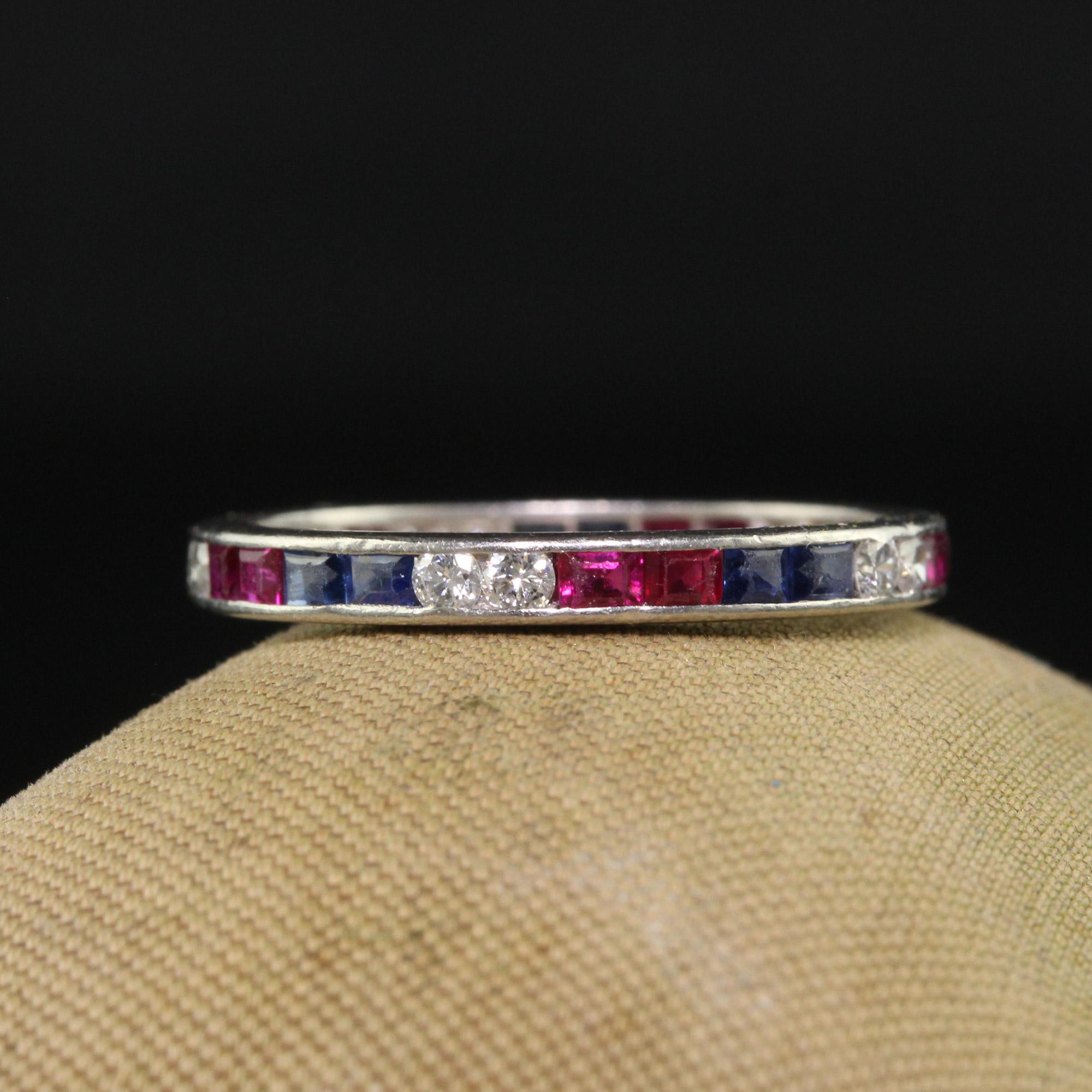 Beautiful Antique Art Deco Platinum Old Cut Diamond Ruby and Sapphire Eternity Band. This incredible art deco eternity band is crafted in platinum. This gorgeous ring features a pattern of diamonds, sapphires and rubies going around the entire ring.