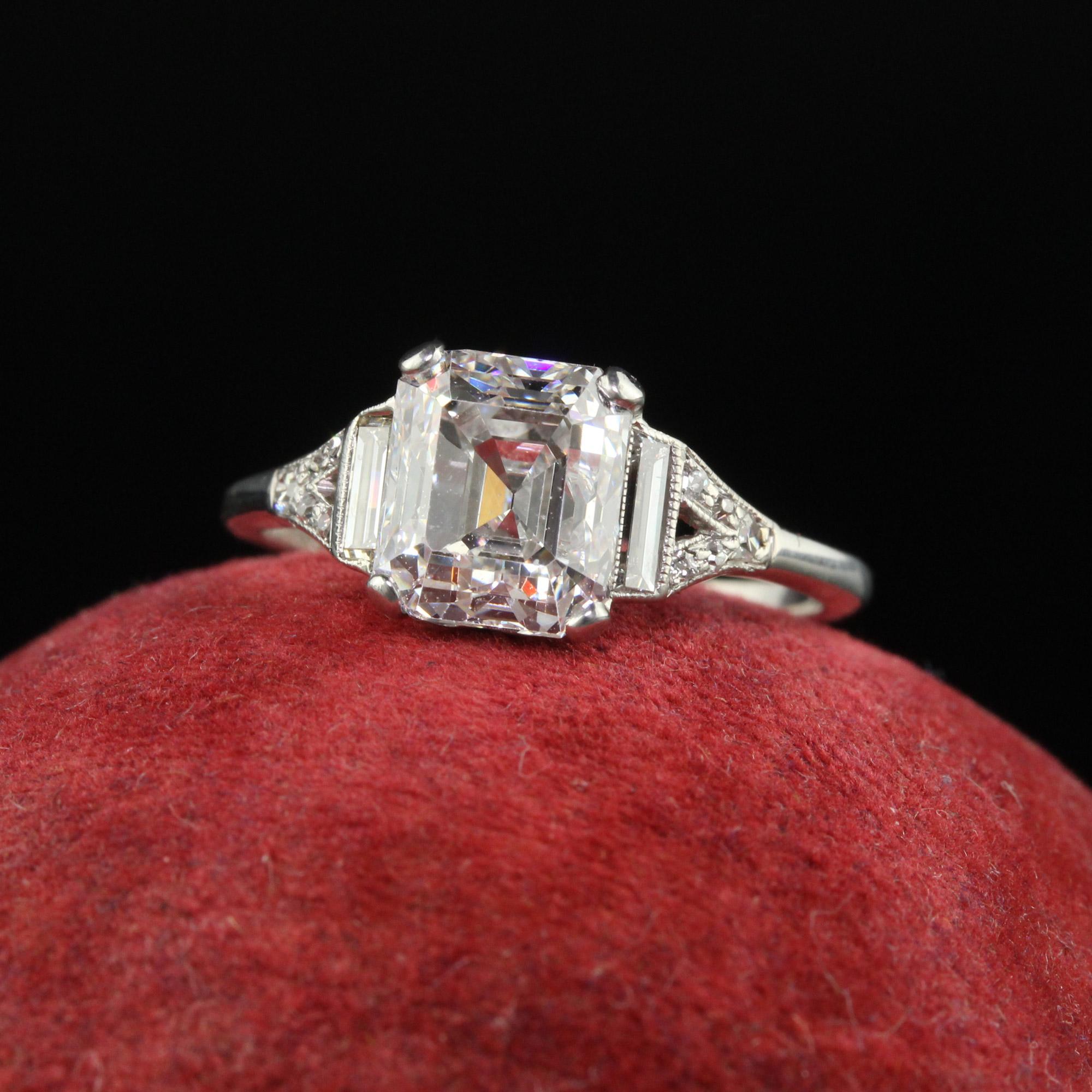 Beautiful Antique Art Deco Platinum Old Emerald Cut Diamond Baguette Engagement Ring - GIA. This gorgeous engagement ring is crafted in platinum. The center holds an exceptional emerald cut diamond that has a GIA report. The diamond is set in a