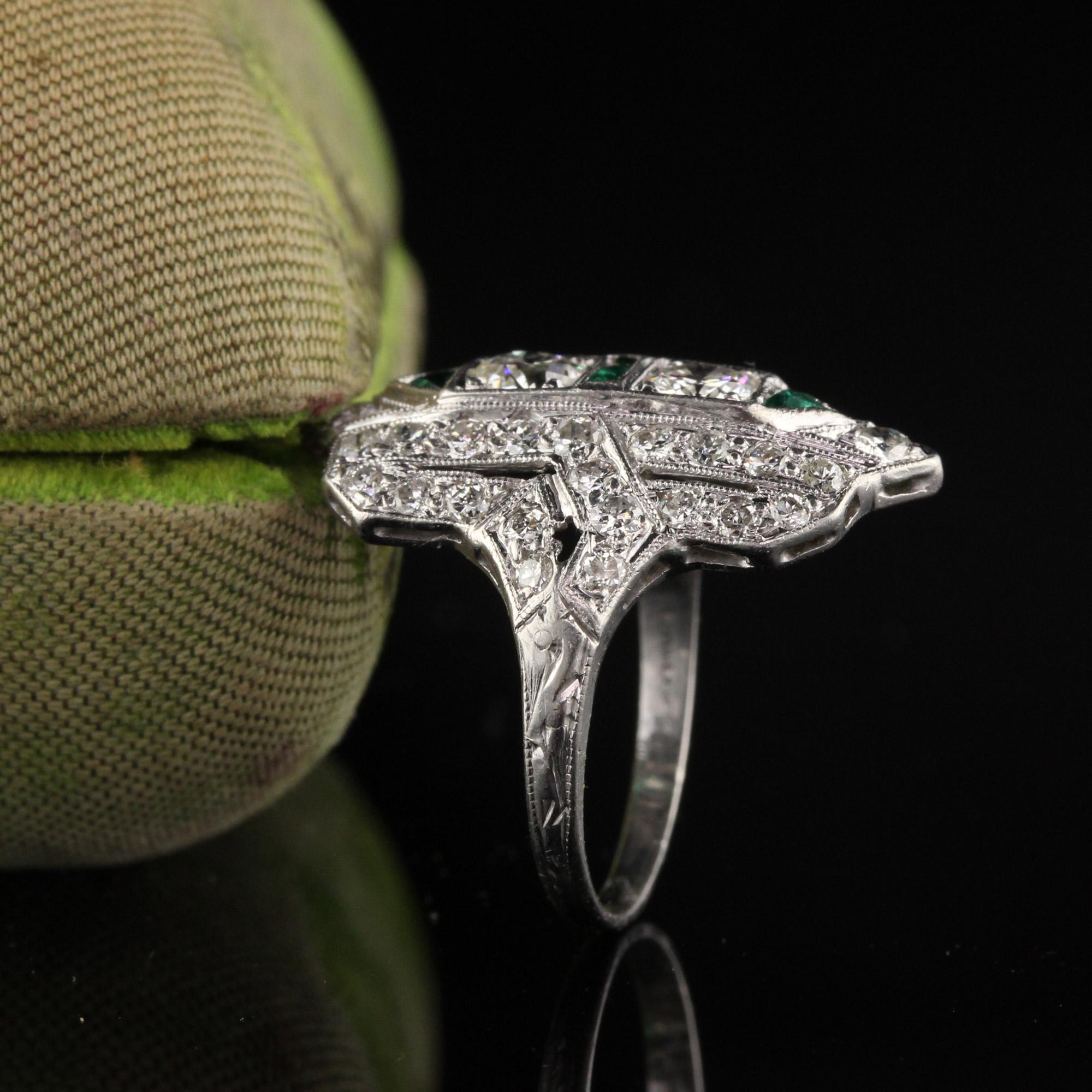 Beautiful antique shield ring with old european cut diamonds and emeralds. 

Item #R0555

Metal: Platinum

Weight: 3.3 Grams

Total Diamond Weight: Approximately 1.00 cts

Diamond Color: H

Diamond Clarity: VS1

Ring Size: 4.25 

This ring can be