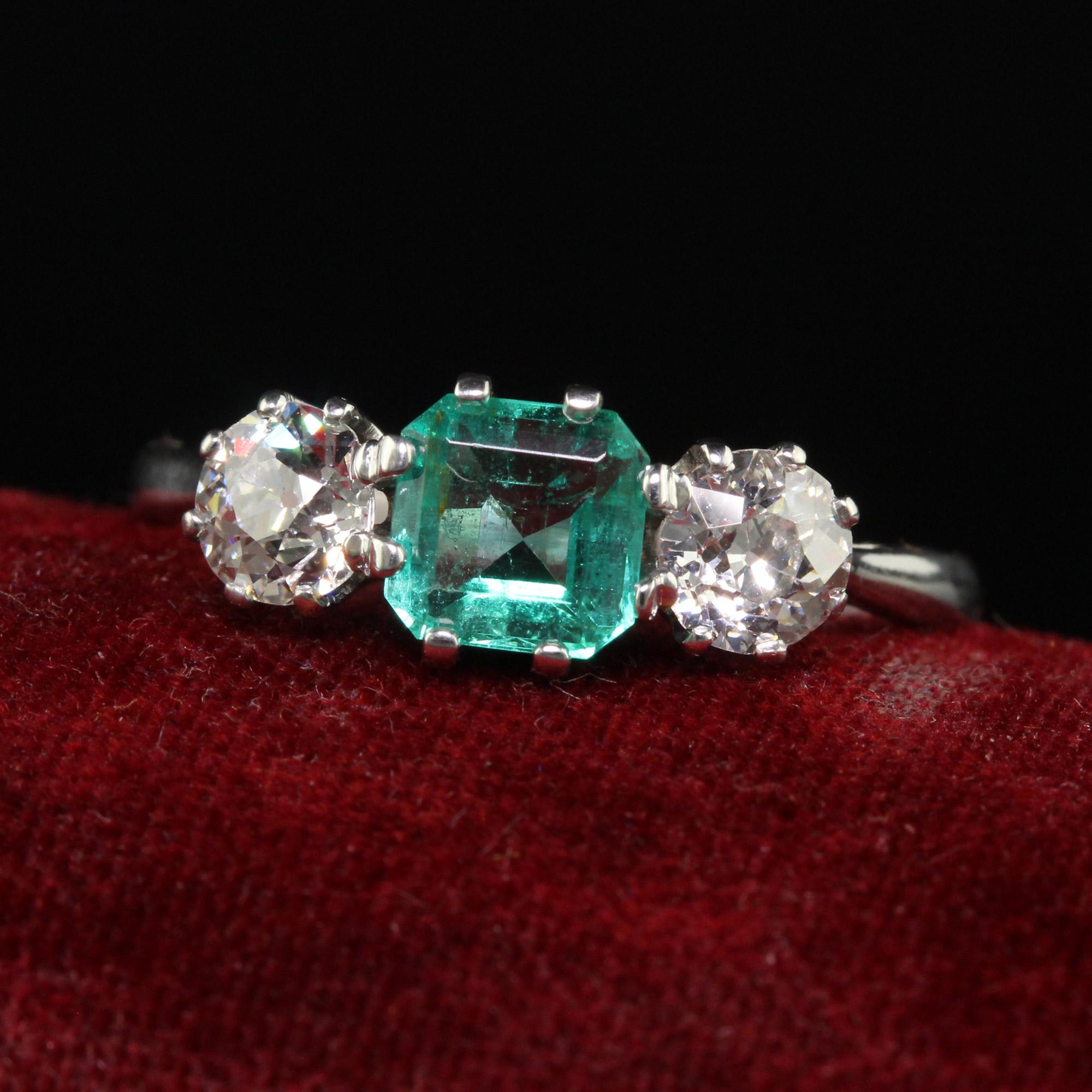 Beautiful Antique Art Deco Platinum Old Euro Diamond and Emerald Three Stone Ring. This beautiful classic art deco three stone ring is crafted in platinum. This gorgeous art deco ring holds a natural green emerald in the center with two old European