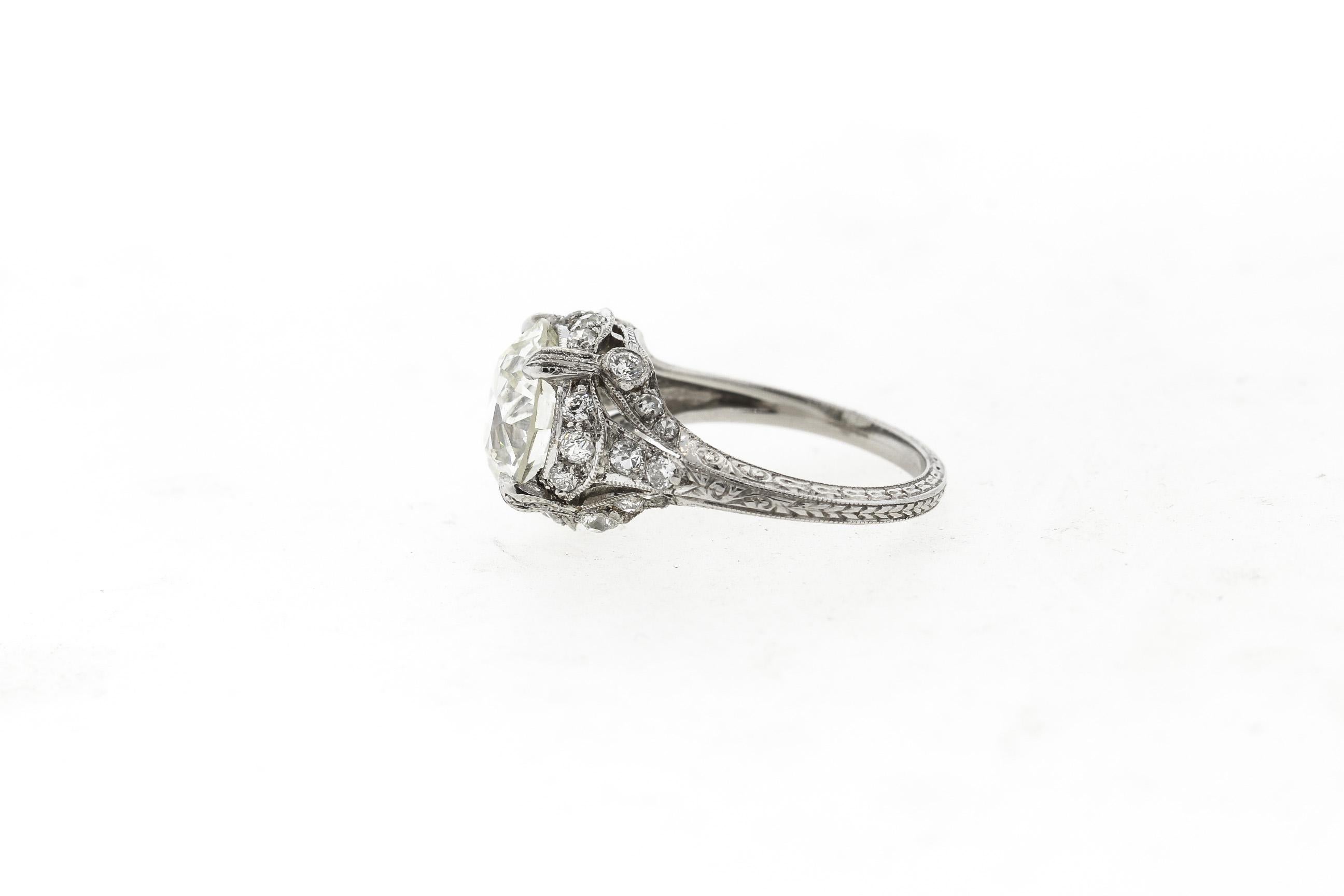 A lovely antique Art Deco platinum solitaire ring centering on an Old European cut diamond weighing 3.35 carats. The diamond has been certified by the Gemological Institute of America and graded as an L color with VS1 clarity. There are additional