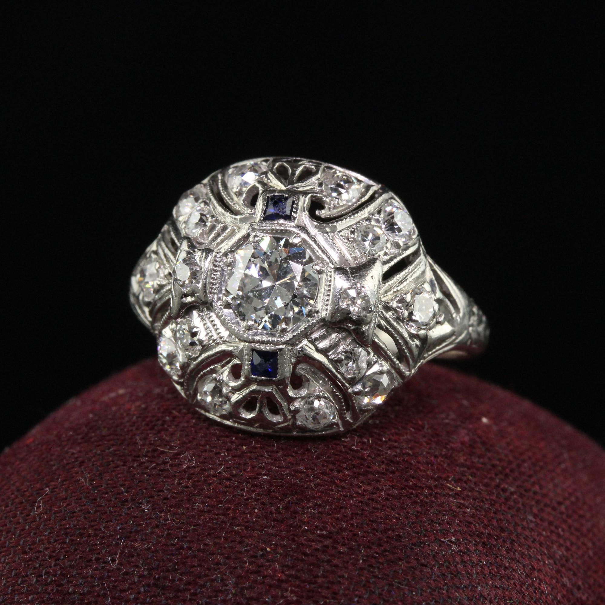 Beautiful Antique Art Deco Platinum Old European Cut Diamond and Sapphire Cocktail Ring. This beautiful ring is crafted in platinum. The ring holds old European cut diamonds that are set in a filigree mounting. The ring is in great condition and