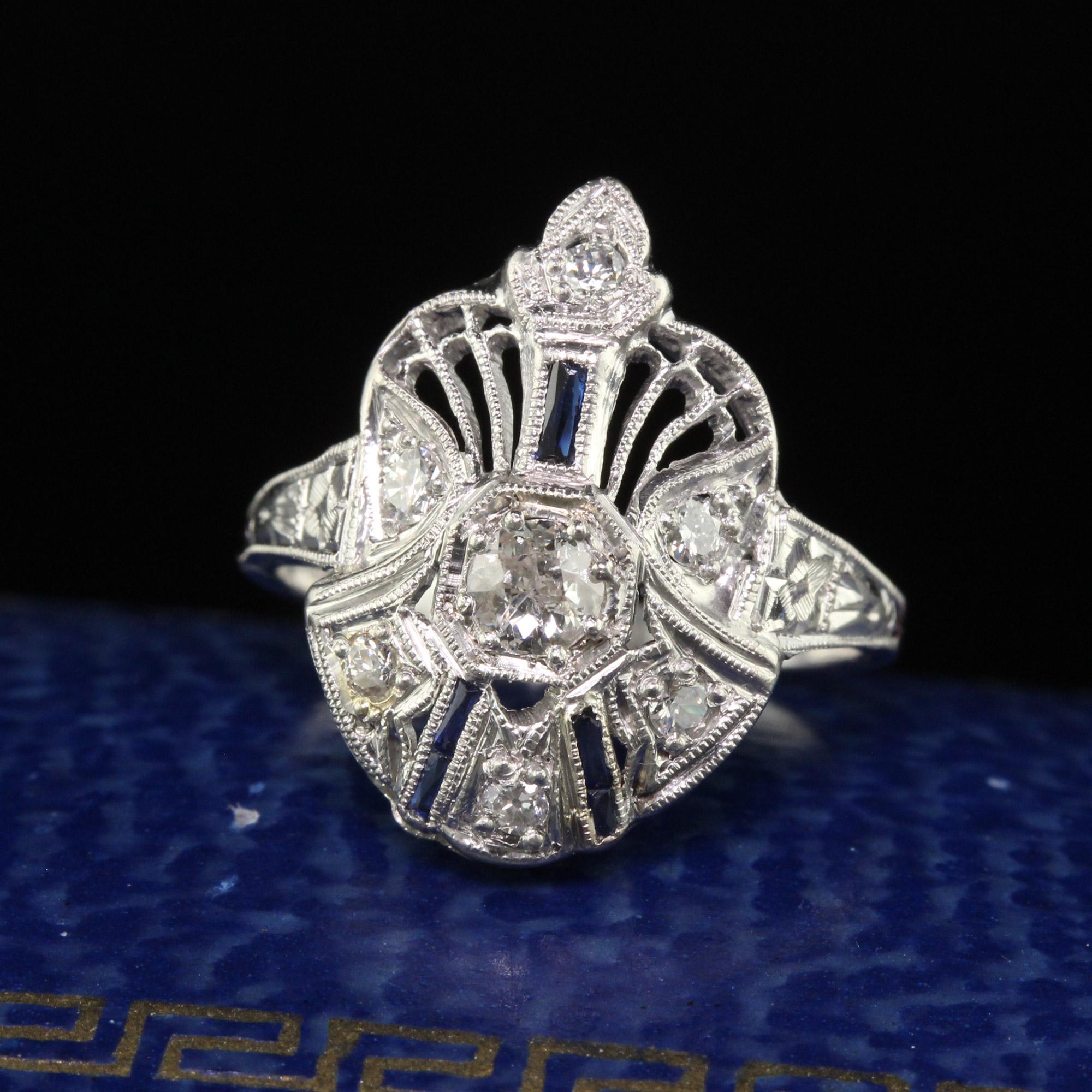 Beautiful Antique Art Deco Platinum Old European Cut Diamond and Sapphire Cocktail Ring. This gorgeous Art Deco cocktail ring is crafted in platinum. The center holds an old European cut diamond and has old cut diamonds and sapphire accents around