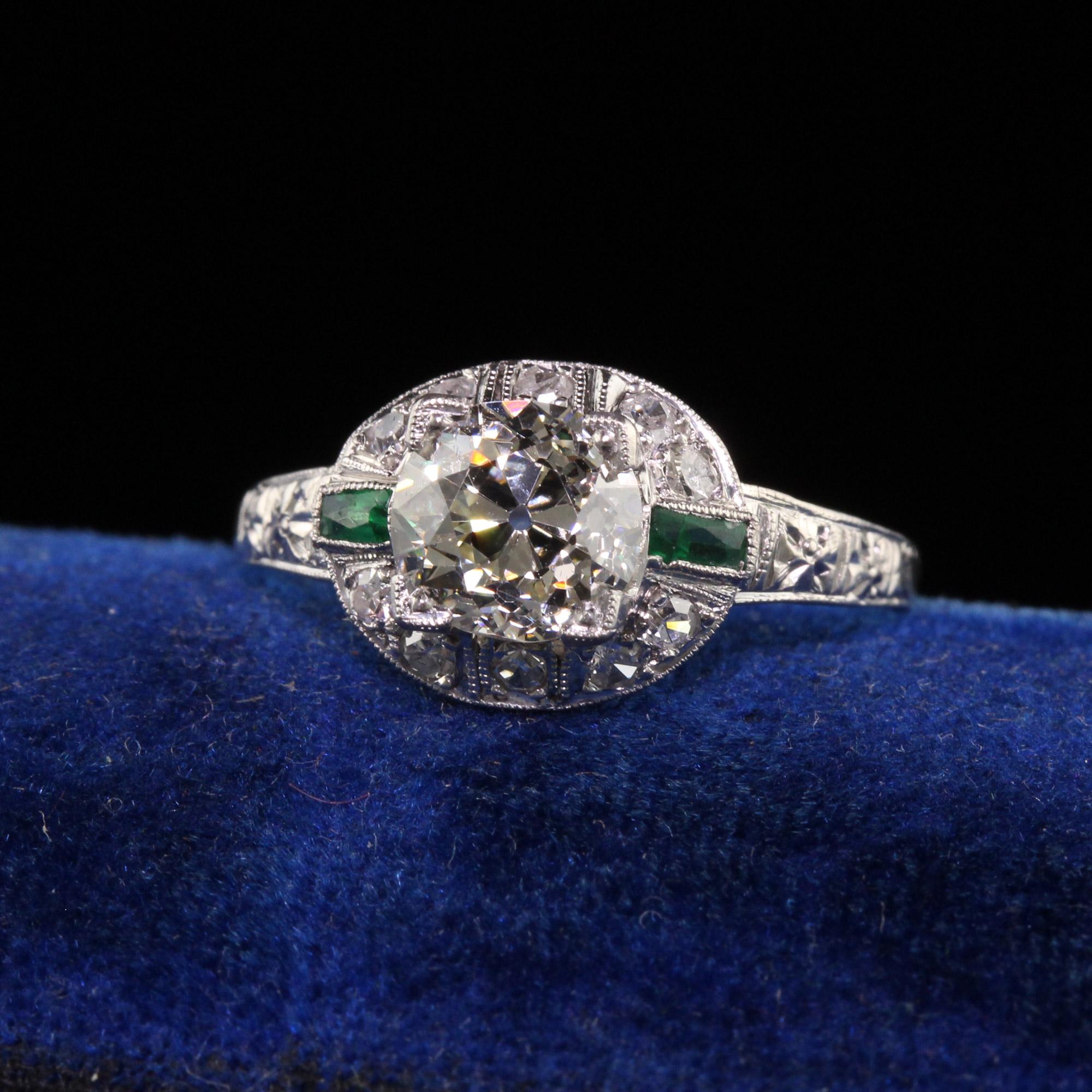 Beautiful Antique Art Deco Platinum Old European Cut Diamond Emerald Engagement Ring. This gorgeous engagement ring is crafted in platinum. The center holds an old european cut diamond and has emeralds on each side with diamonds above and below. The
