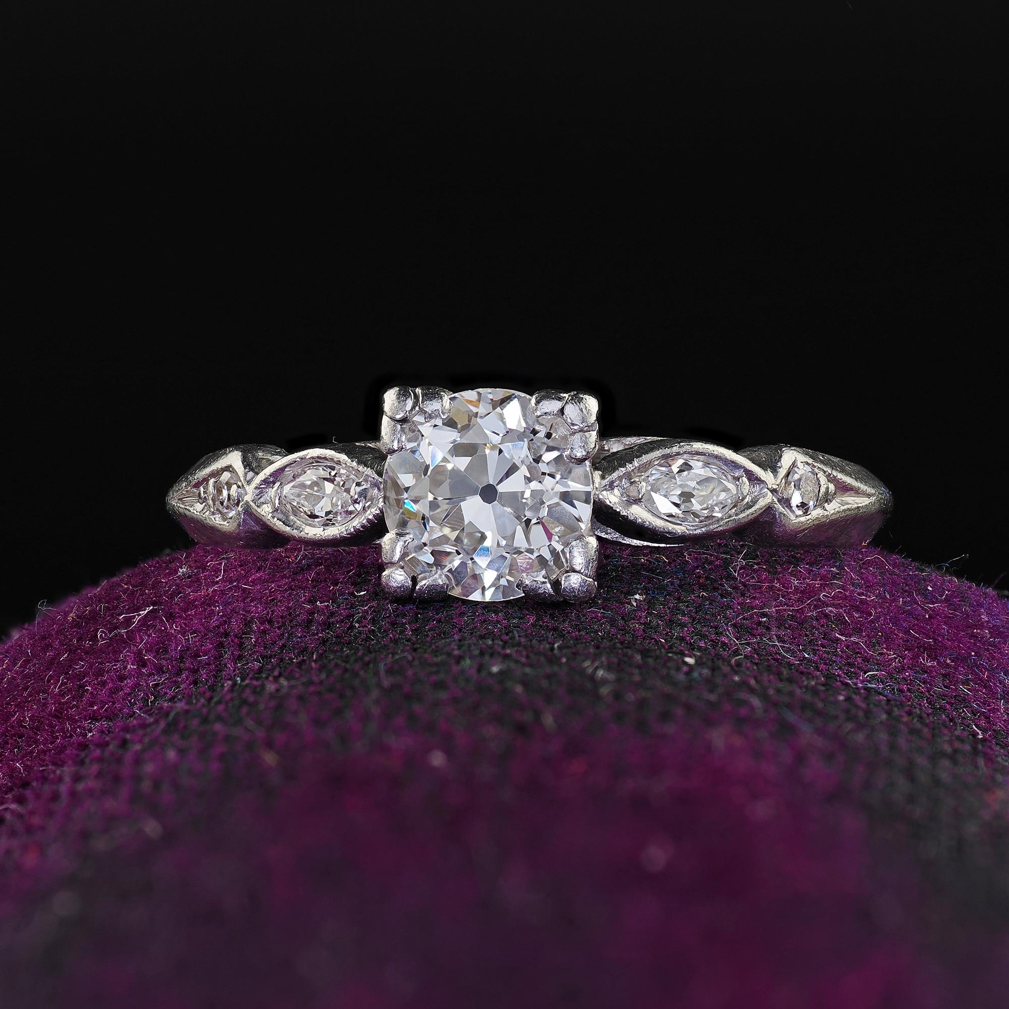 Beautiful Antique Art Deco Platinum Old European Cut Diamond Engagement Ring. This classic Art Deco old Euro engagement ring is crafted in platinum. The ring features a beautiful old European cut in the center and old marquise cut diamonds on the