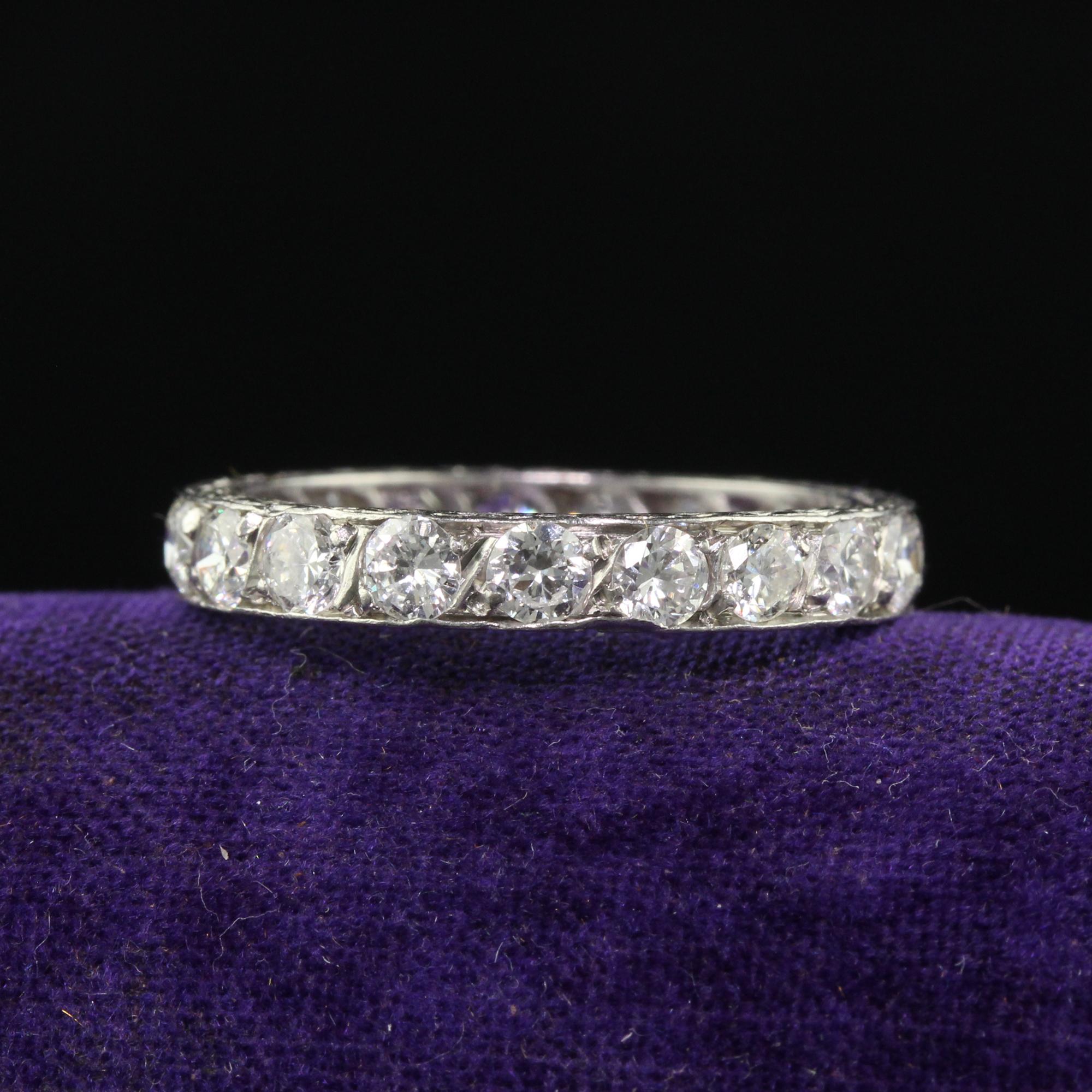 Beautiful Antique Art Deco Platinum Old European Cut Diamond Engraved Eternity Band. This gorgeous art deco eternity band is crafted in platinum. The ring has beautiful white old cut diamonds going around the entire ring. The sides of the ring have
