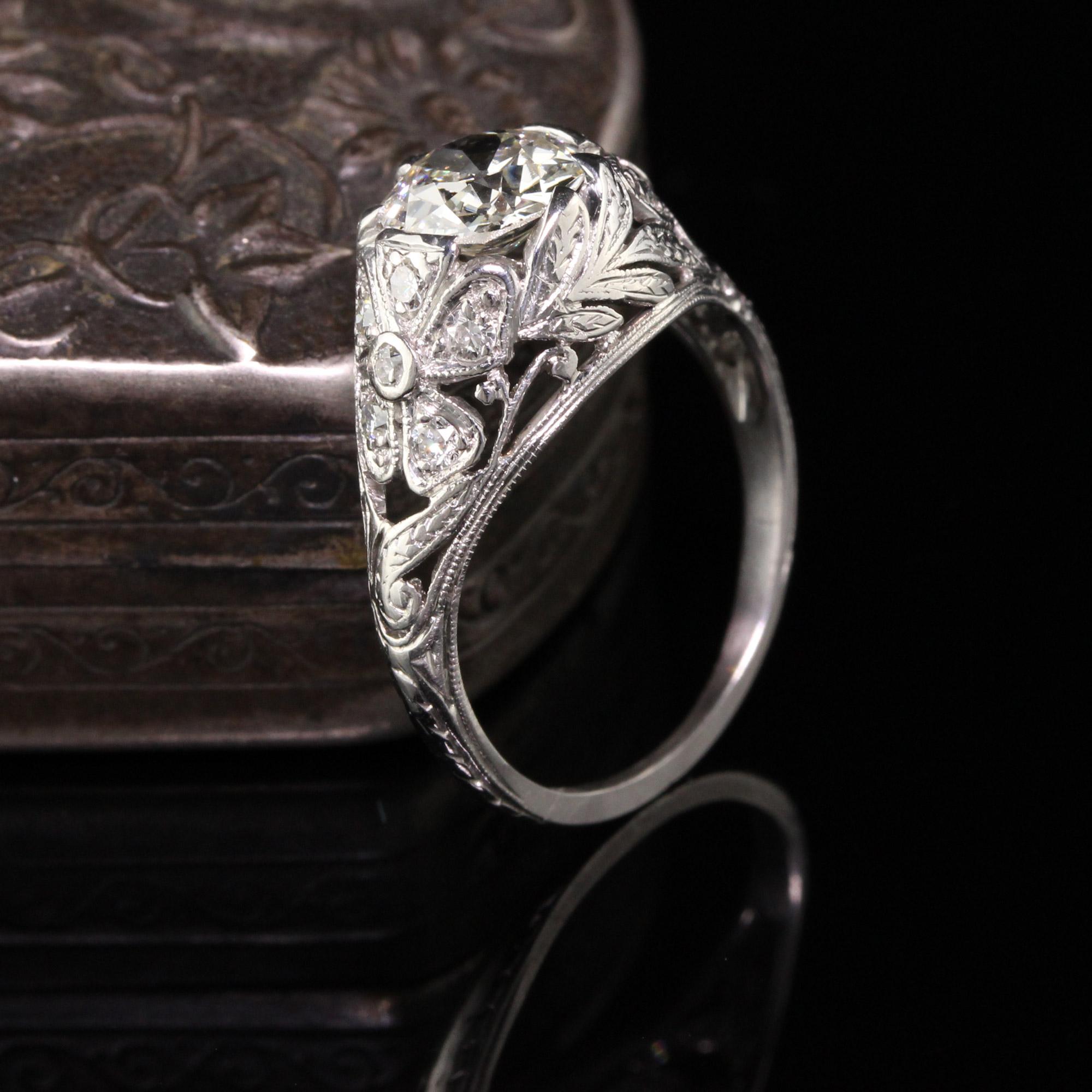 Gorgeous Antique Art Deco Platinum Old European Cut Diamond Floral Engagement Ring. This beautiful ring features a 1.06 ct Old European cut diamond in the center of a beautiful floral art deco mounting. The center is held by the petals of the