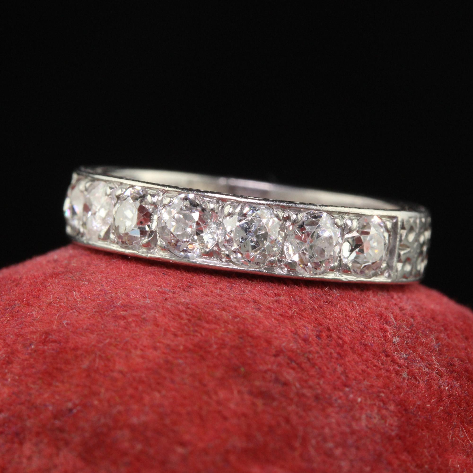 Beautiful Antique Art Deco Platinum Old European Cut Seven Diamond Engraved Band. This gorgeous wedding band is crafted in platinum. The top has seven chunky old European cut diamonds set in an engraved Art Deco band. The ring sits low on the finger