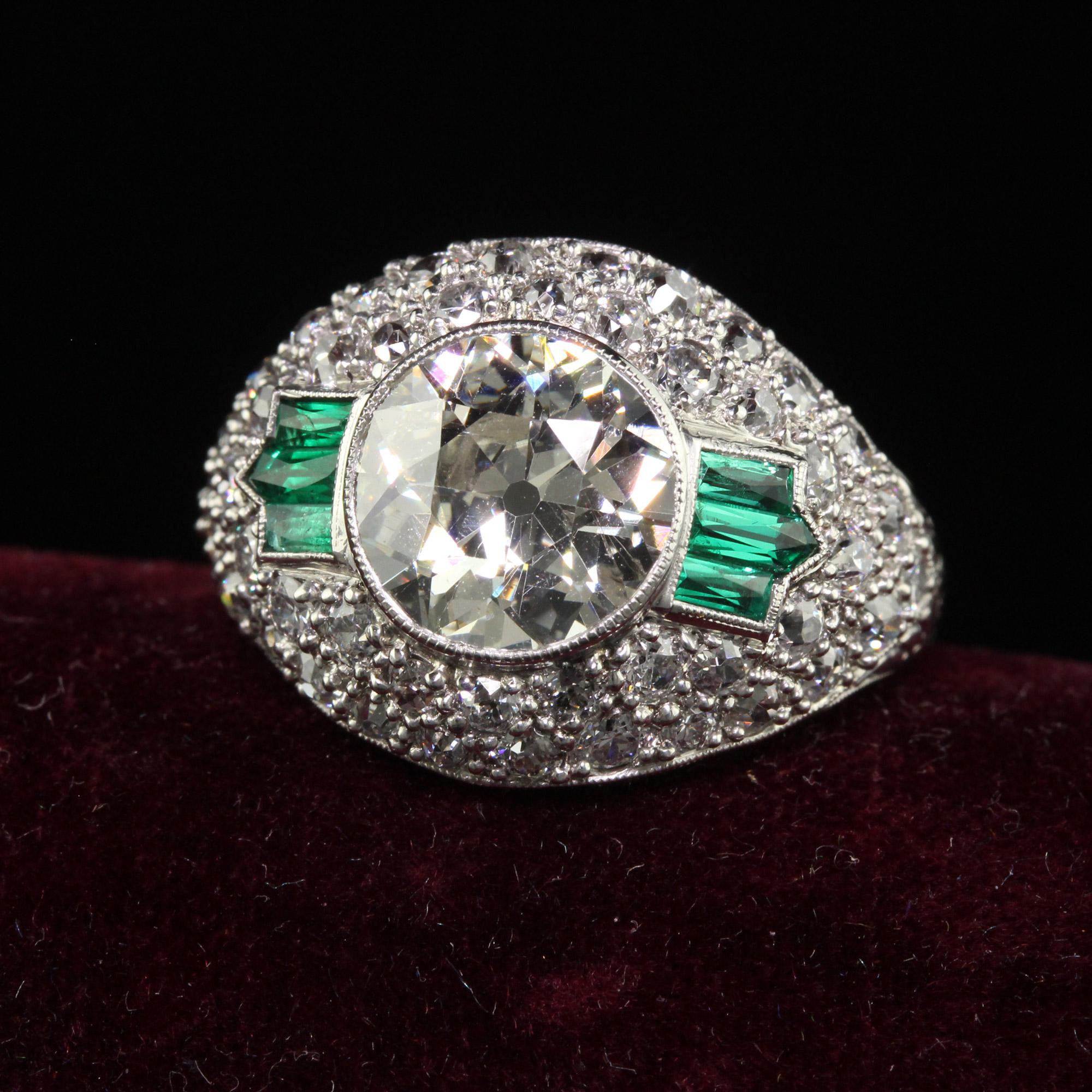 Beautiful Antique Art Deco Platinum Old European Diamond and Emerald Engagement Ring - GIA. This incredible art deco old European diamond engagement ring is crafted in platinum. The center holds a gorgeous old European cut diamond that has a GIA