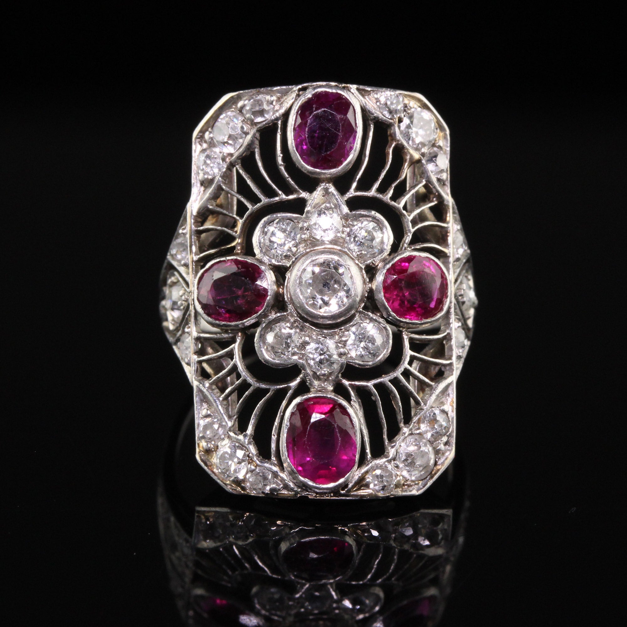 Beautiful Antique Art Deco Platinum Old European Diamond and Ruby Filigree Shield Ring. This incredible shield ring is crafted in platinum. The ring holds old european diamonds and natural rubies. The ring is in great condition and sits low on the