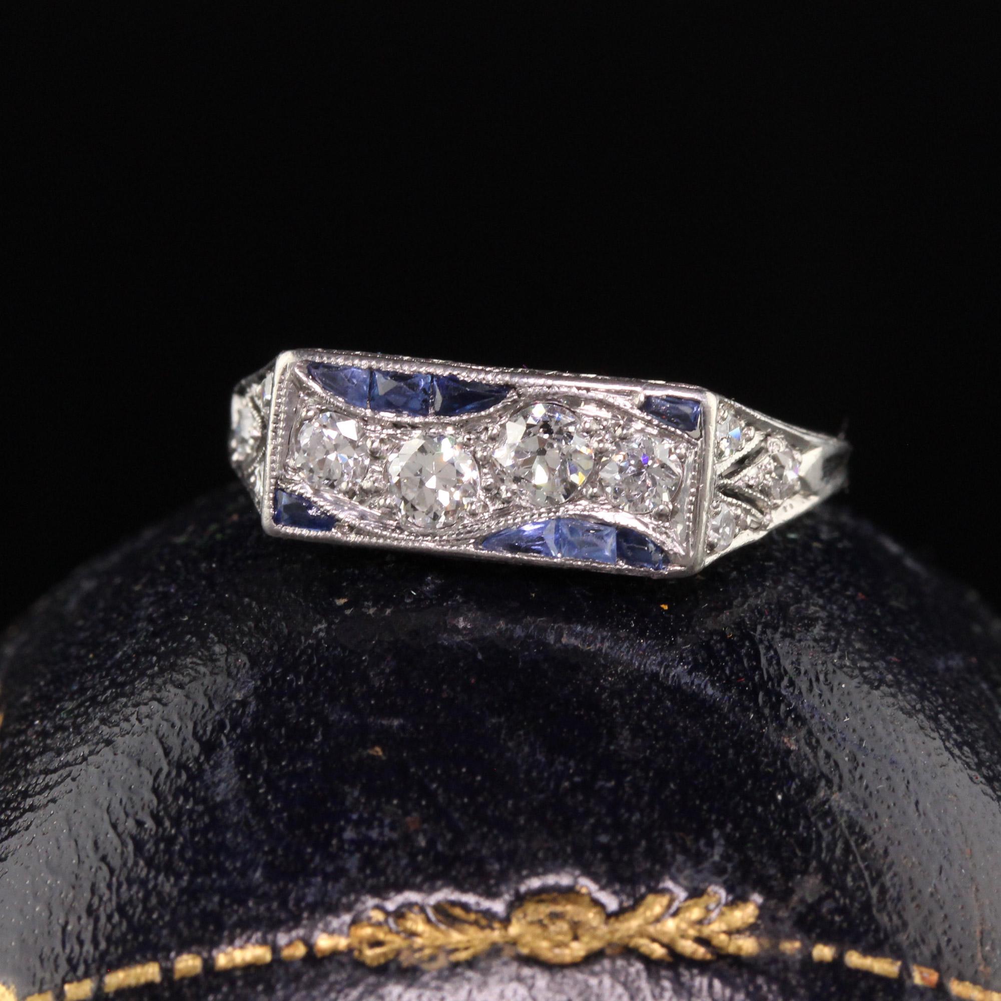 Beautiful Antique Art Deco Platinum Old European Diamond and Sapphire Engraved Ring. This gorgeous ring is crafted in platinum and has crisp engravings going around the ring. The ring is set with old european cut diamonds and french cut sapphires