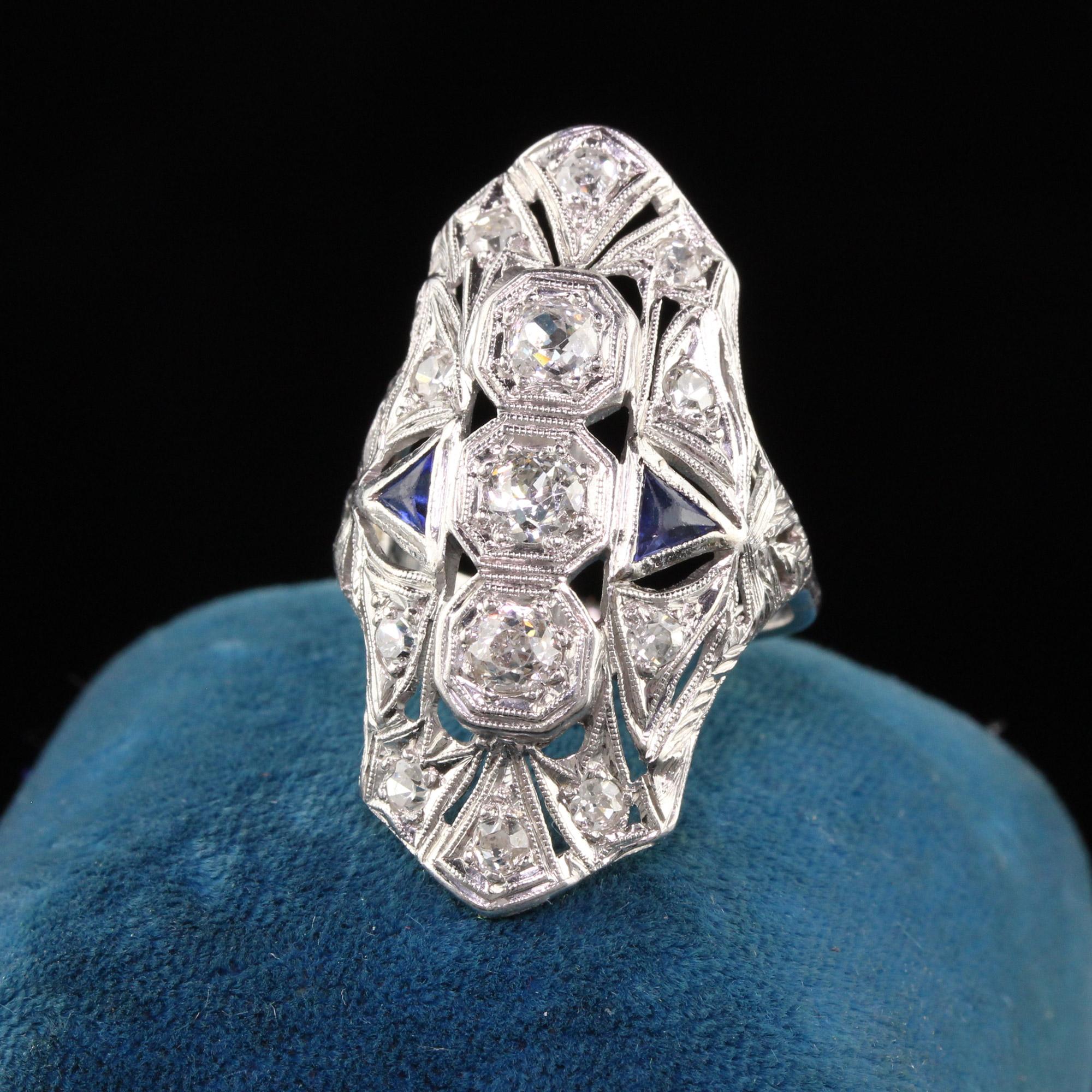 Beautiful Antique Art Deco Platinum Old European Diamond and Sapphire Shield Ring. This impressive Art Deco shield ring is crafted in platinum and has beautiful old european cut diamonds all on the ring with trillion cut sapphires on each