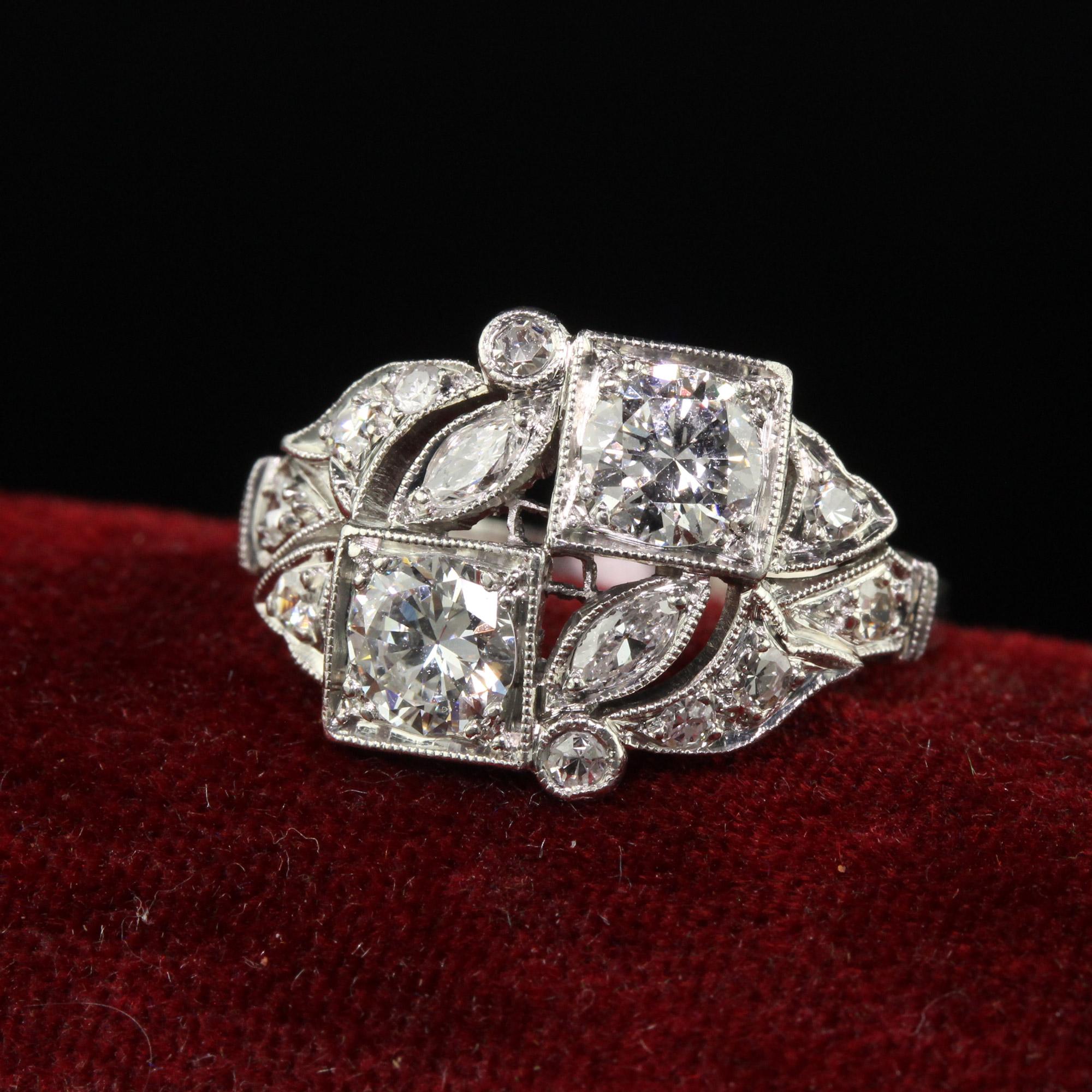 Beautiful Antique Art Deco Platinum Old European Diamond Filigree Toi et Moi Floral Ring. This incredible Art Deco ring is crafted in platinum. The ring has two old euro cut diamonds set diagonally on the ring with old cut marquise on either side.