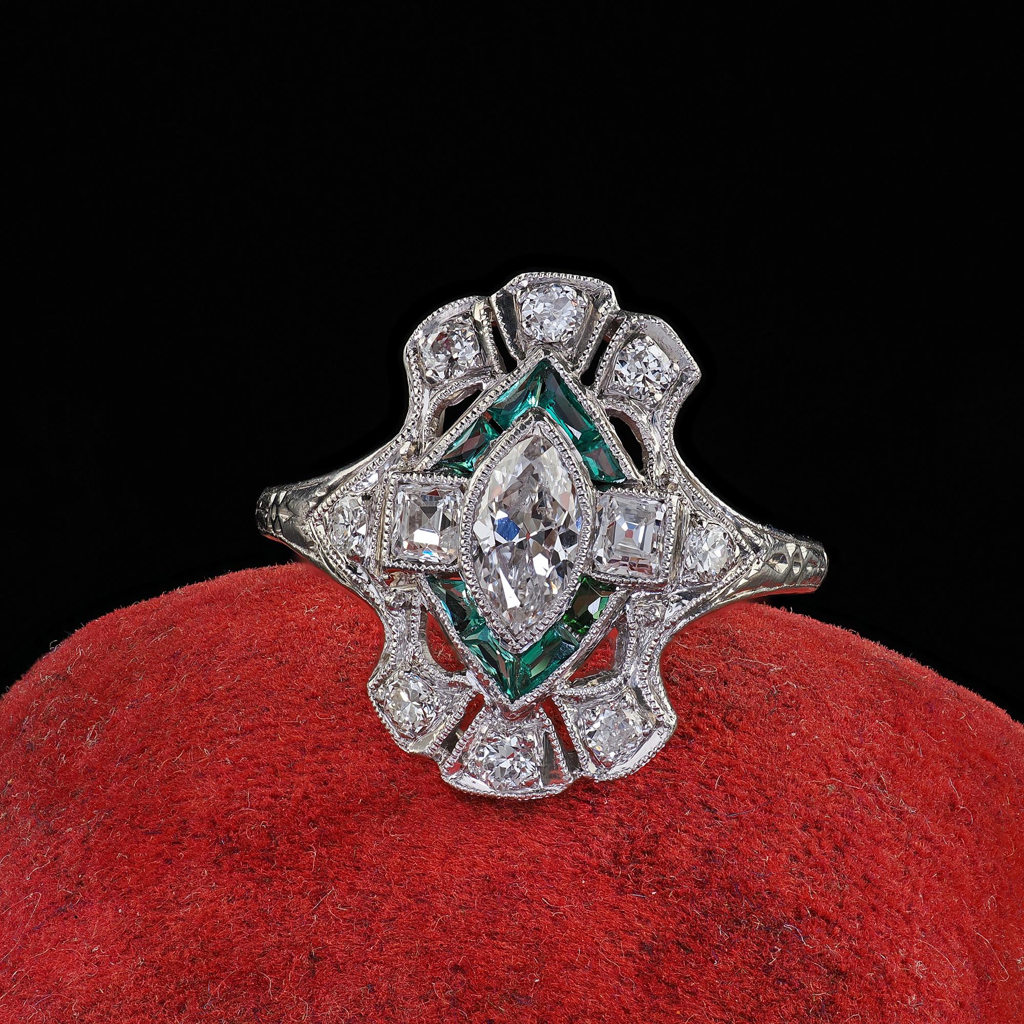 Beautiful Antique Art Deco Platinum Old Marquise Carre Cut Diamond Emerald Shield Ring. This beautiful Antique Art Deco old cut marquise and emerald shield ring is crafted in platinum. The ring features a beautiful old cut marquise in the center and