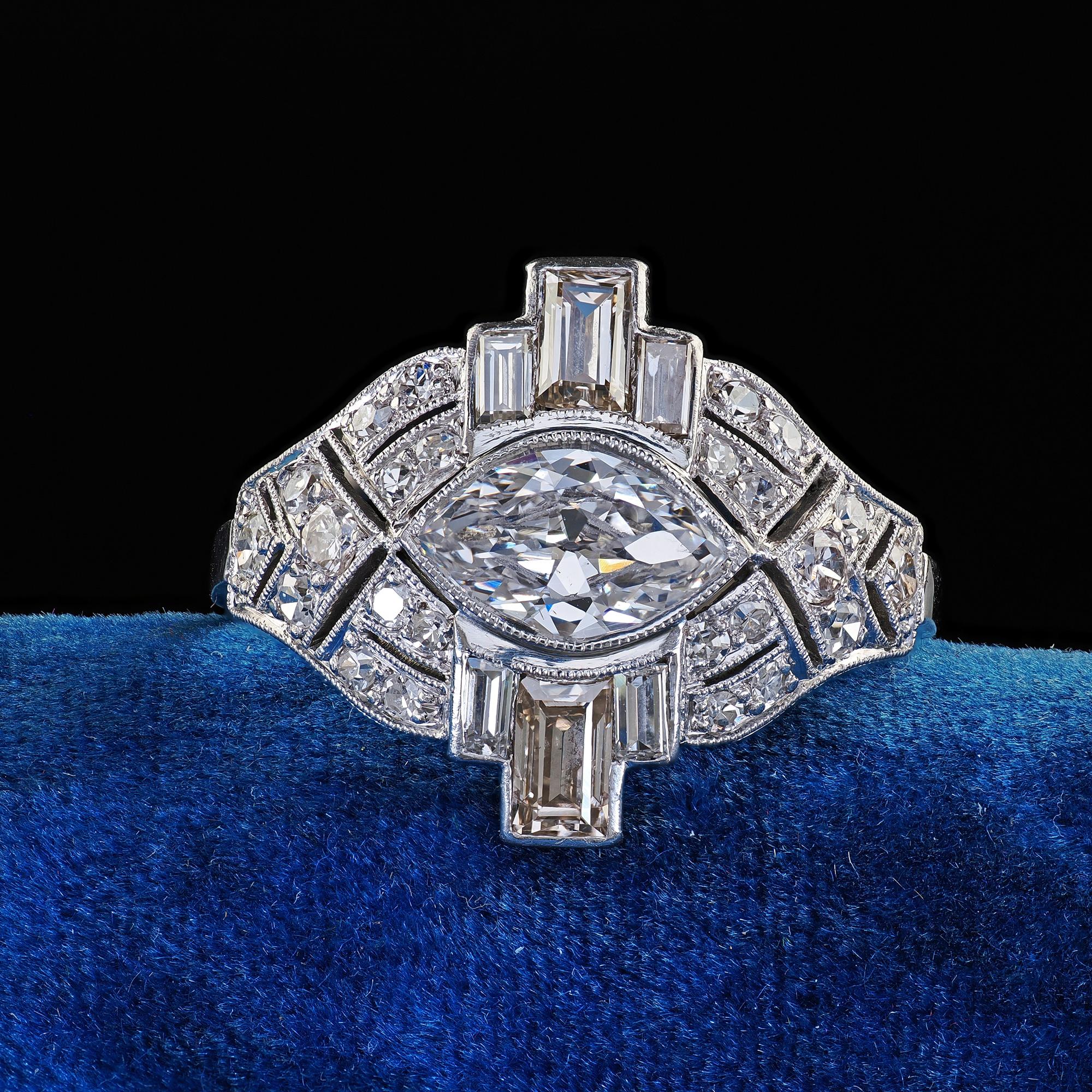 Beautiful Antique Art Deco Platinum Old Marquise Diamond Baguette Engagement Ring. This incredible Art Deco old marquise diamond baguette engagement ring is crafted in platinum. This amazing ring features an old cut marquise in the center of a