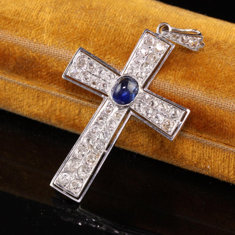 Beautiful Antique Art Deco Platinum Old Mine Cut Diamond and Sapphire Cross Pendant. This gorgeous art deco pendant has old mine cut diamonds all over the cross with a beautiful natural blue sapphire in the center.

Item #N0070

Metal: