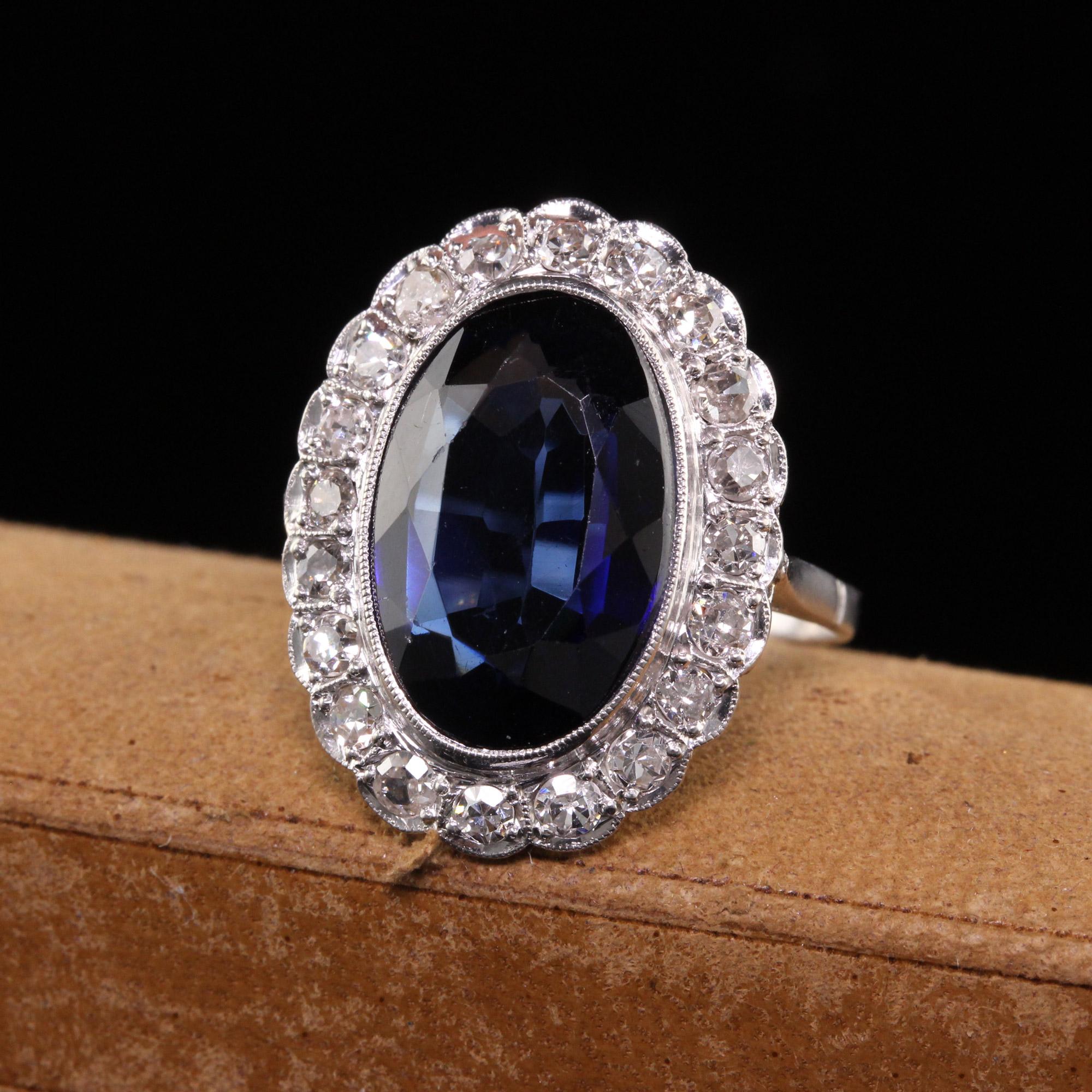 Beautiful Antique Art Deco Platinum Old Mine Cut Diamond and Sapphire Ring. This beautiful ring is crafted in platinum. The center holds a large synthetic sapphire and is surrounded by old mine cut diamonds in a classic 