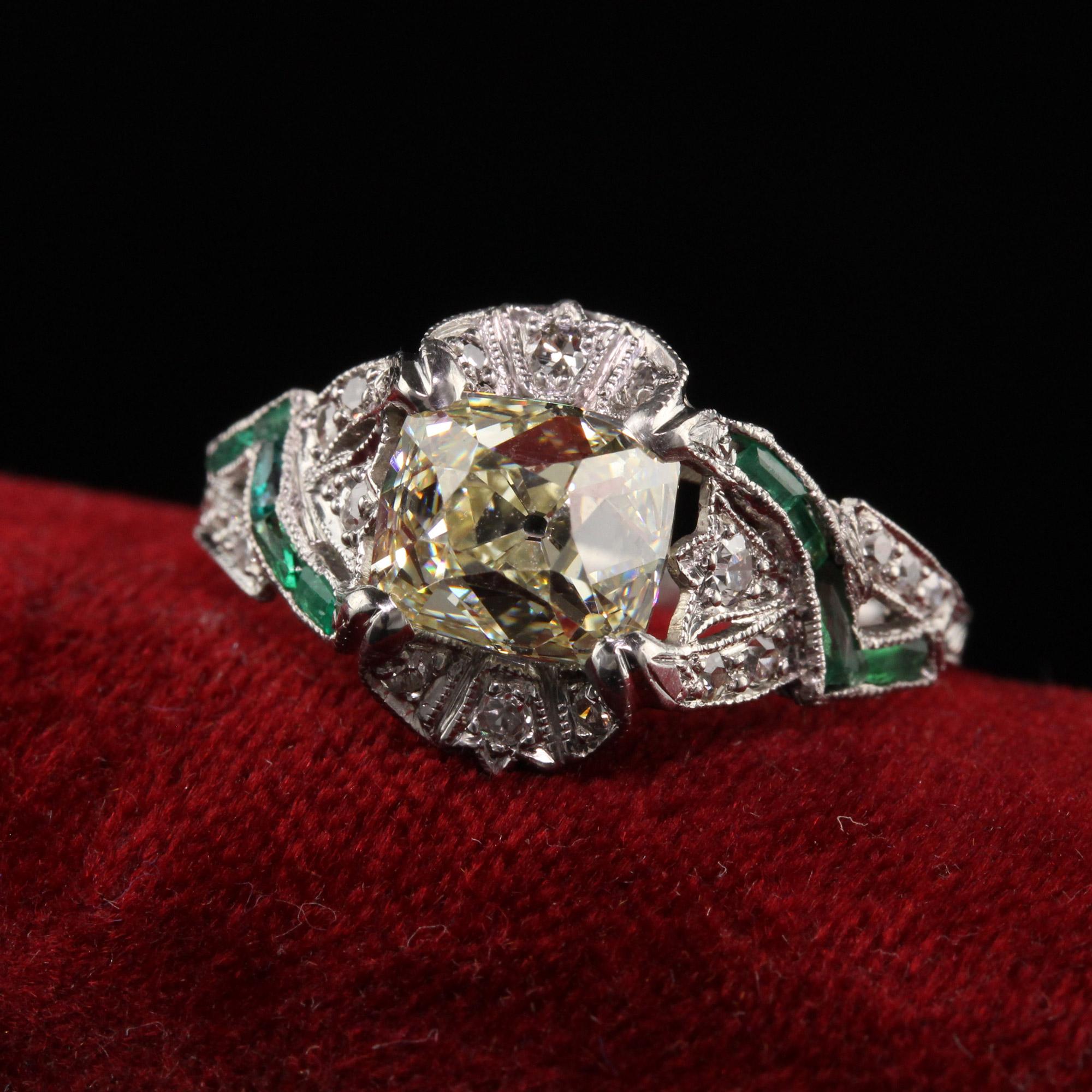 Beautiful Antique Art Deco Platinum Old Mine Cut Diamond Emerald Engagement Ring. This gorgeous engagement ring is crafted in platinum. The center holds a chunky old mine cut diamond that is set in a gorgeous filigree mounting with single cut