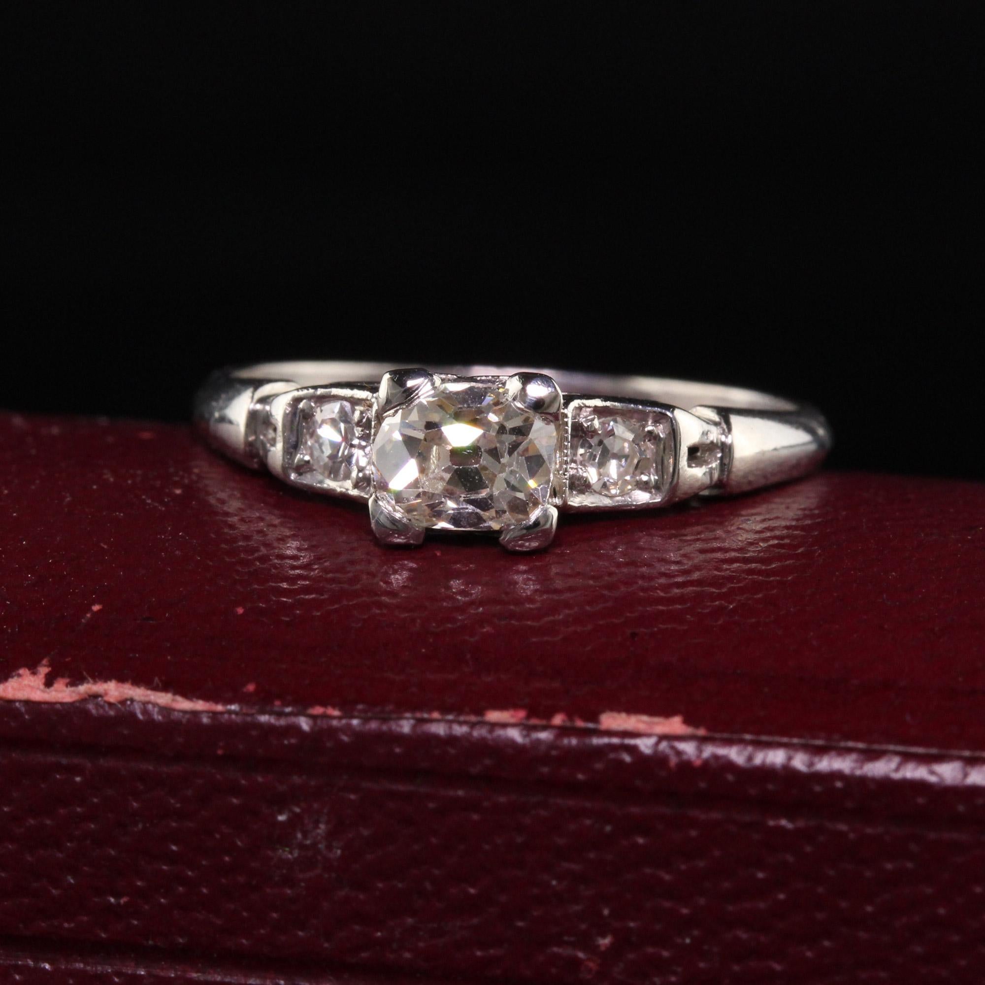 Beautiful Antique Art Deco Platinum Old Mine Cut Diamond Engagement Ring. This beautiful ring is crafted in platinum. The center holds a beautiful old mine cut diamond that is set east to west and the sides hold two old european cut diamonds. It is