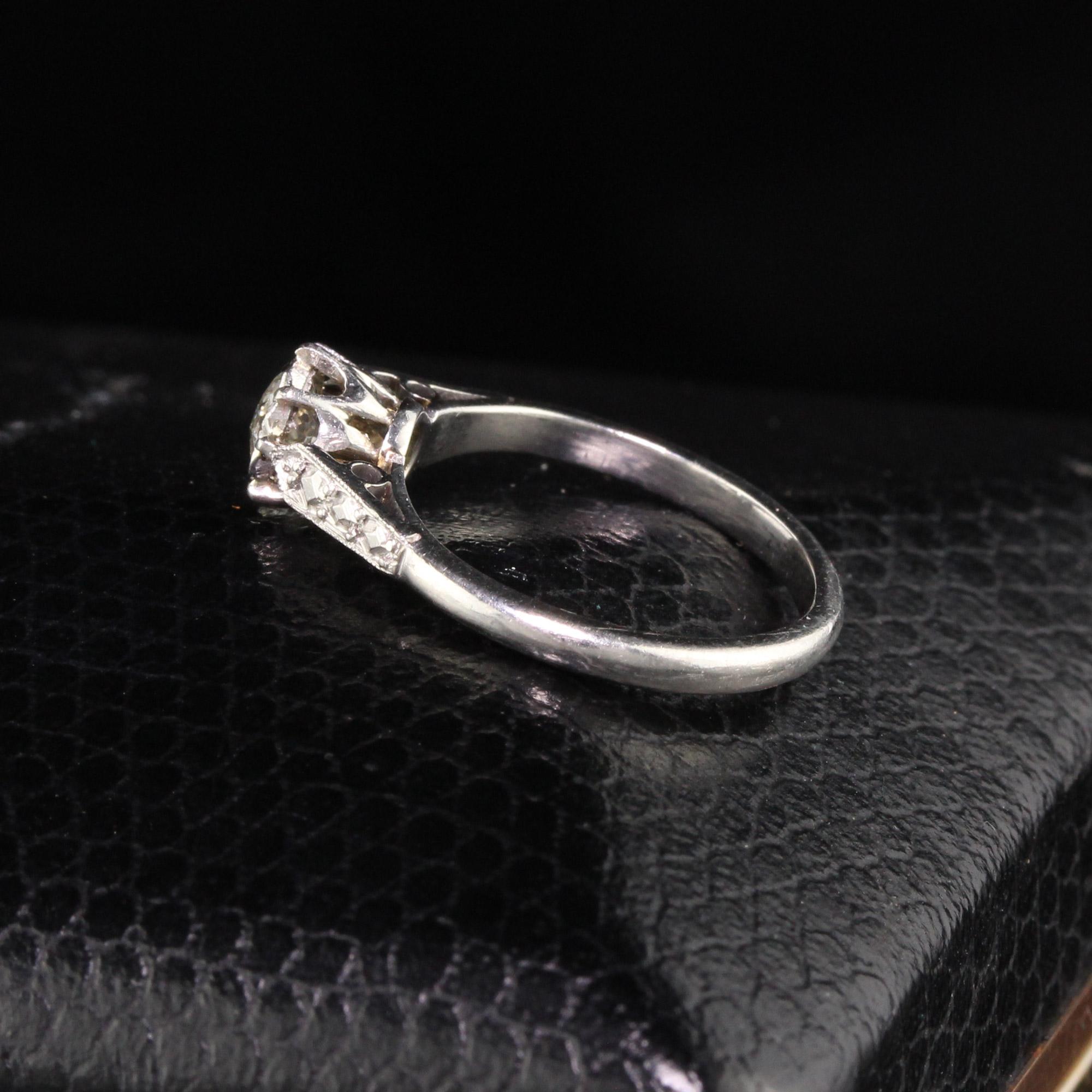 Gorgeous Antique Art Deco Platinum Old Mine Cut Diamond Engagement Ring. The center stone is an old mine cut diamond measuring approximately .45 cts and the mounting has diamond cut engravings on the sides to give the illusion of diamond