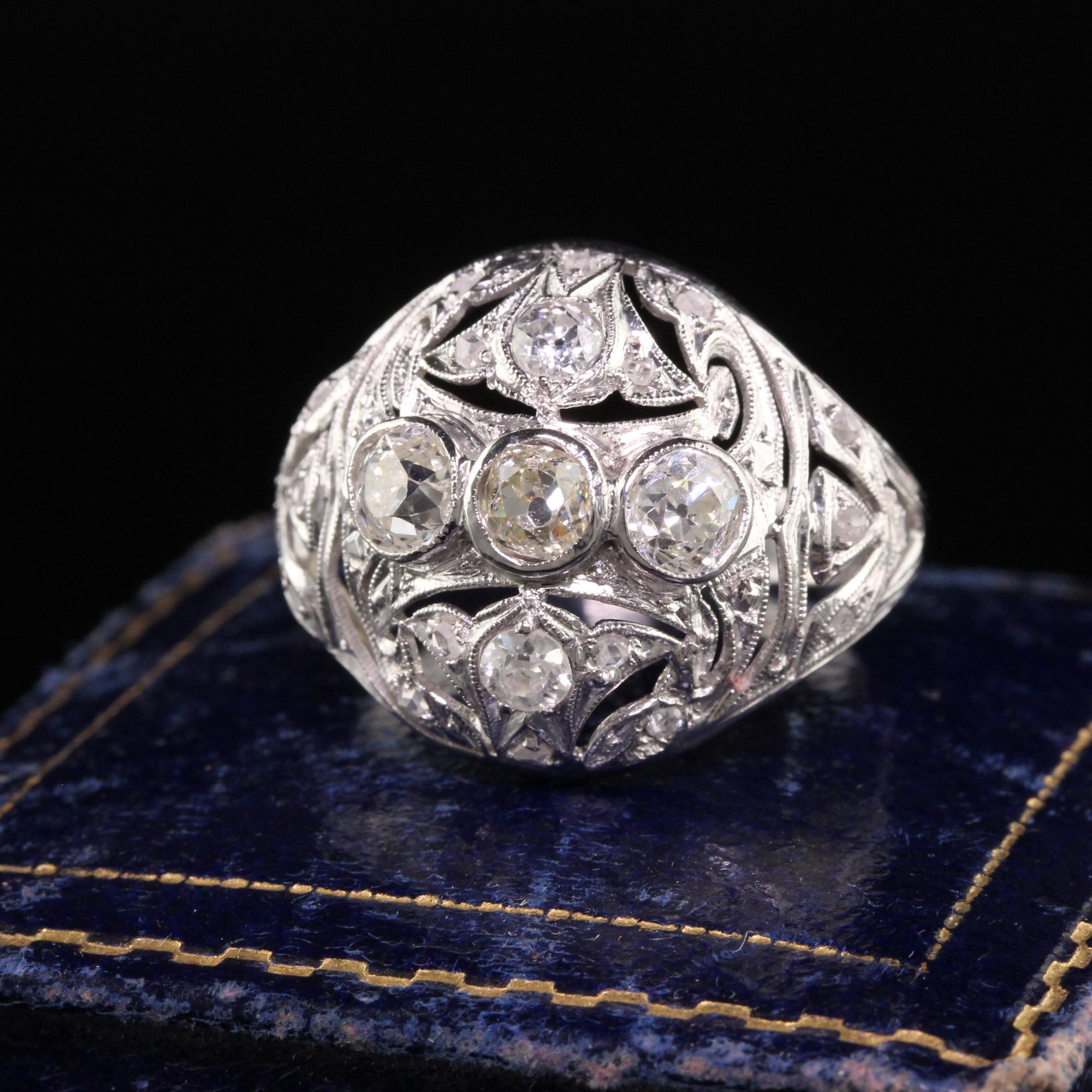 Beautiful Antique Art Deco Platinum Old Mine Diamond Filigree Cocktail Ring. This beautiful ring is crafted in platinum. The ring holds old mine, old European, and rose cut diamonds on it. There is a beautiful floral pattern and in good condition.