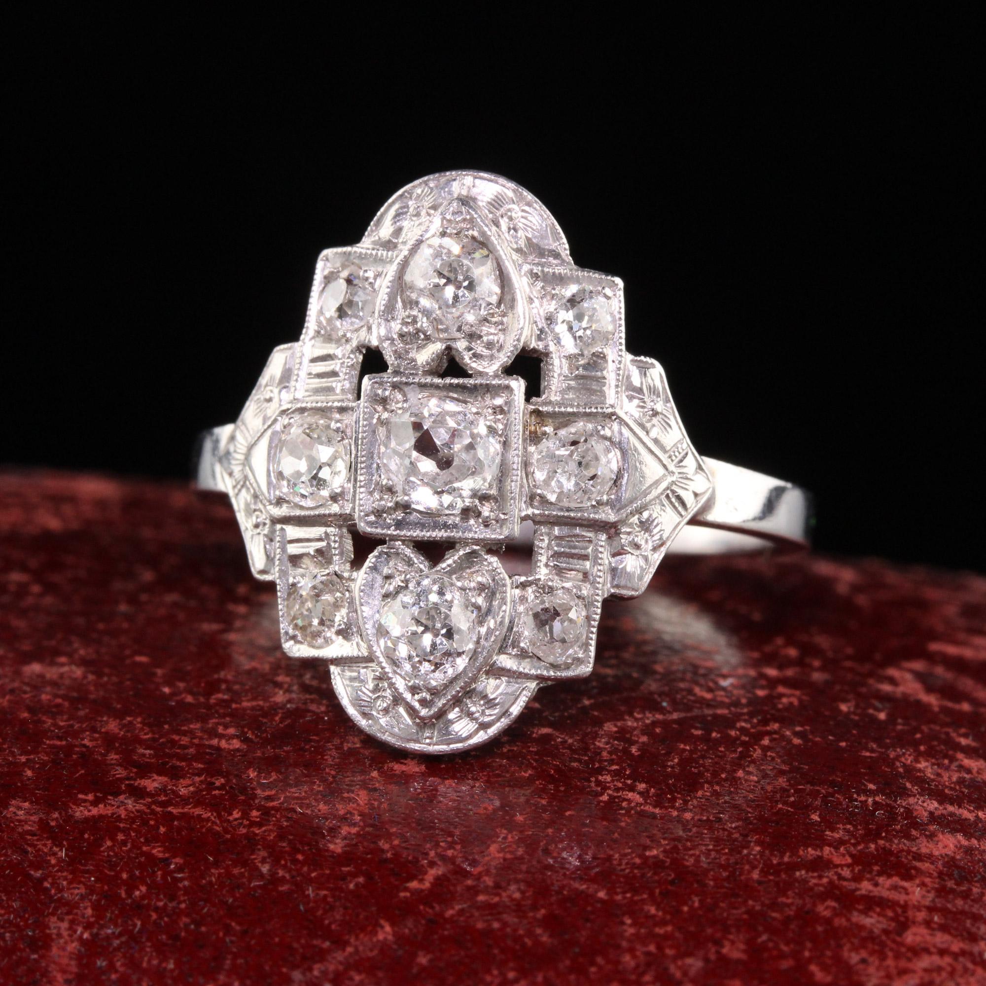 Beautiful Antique Art Deco Platinum Old Mine Diamond Heart Design Shield Ring. This gorgeous ring is crafted in platinum. The ring has old mine cut diamond set throughout the ring and has a beautiful heart shape pattern on top where the diamonds are