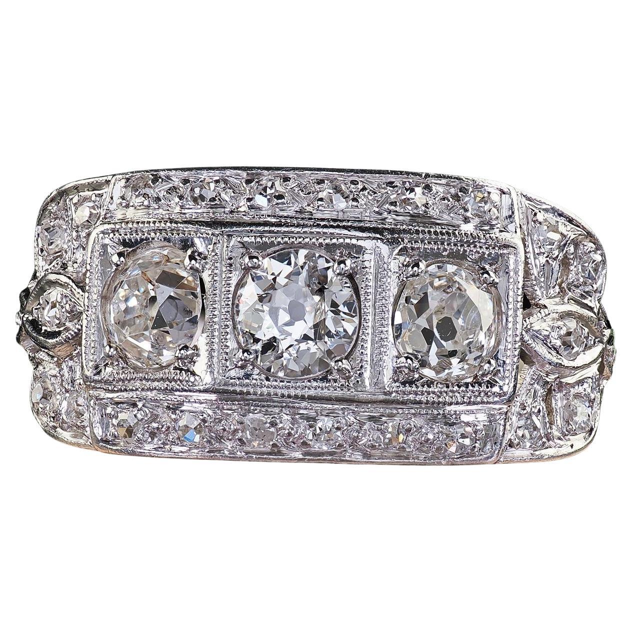 Antique Art Deco Platinum Old Mine Diamond Three Stone Ribbon Motif Ring For Sale