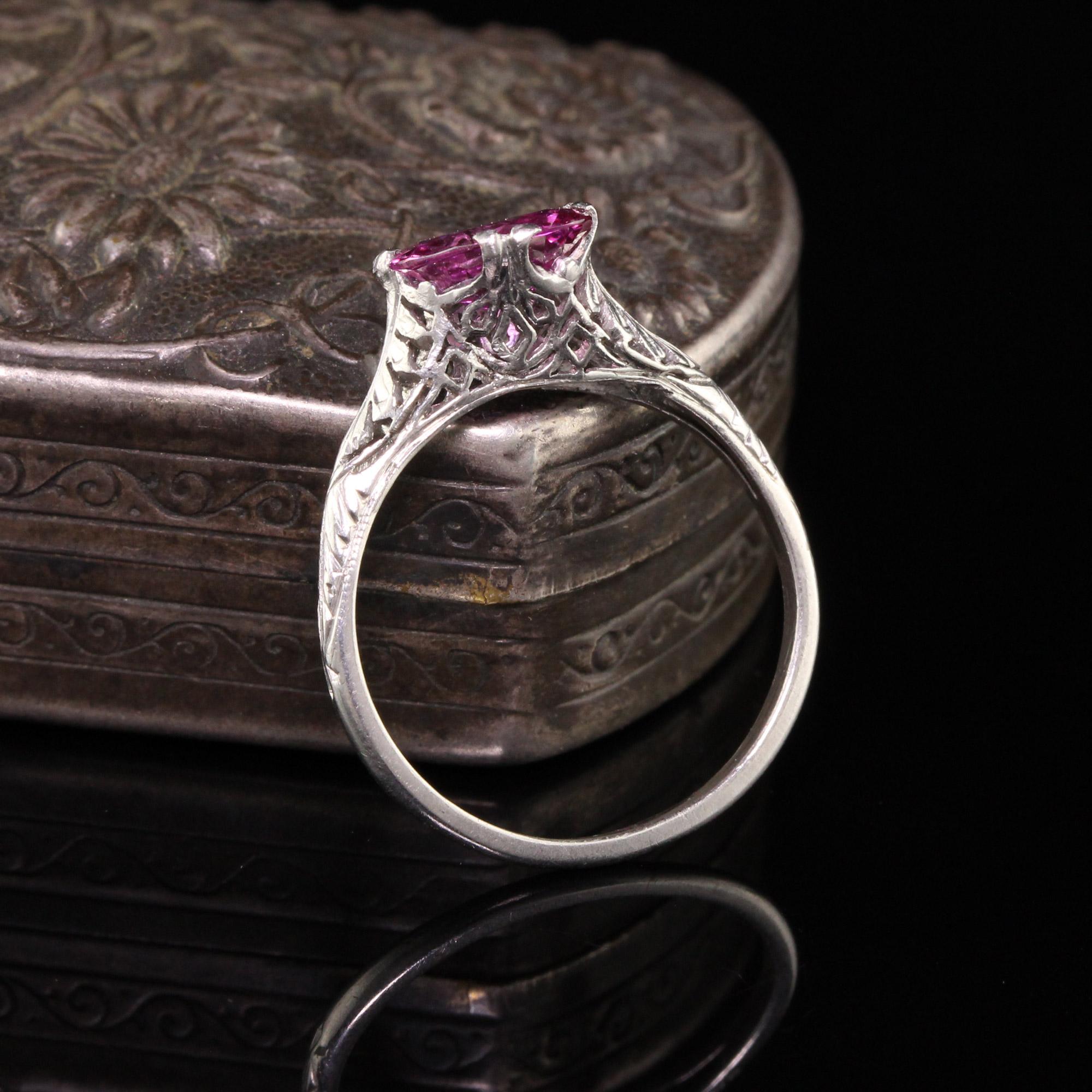 Beautiful Antique Art Deco Platinum Oval Pink Sapphire Filigree Engagement Ring. This unique engagement ring features a NO HEAT bubble gum pink sapphire in a very unique mounting. The stone is set sideways and the filigree and mounting itself. The