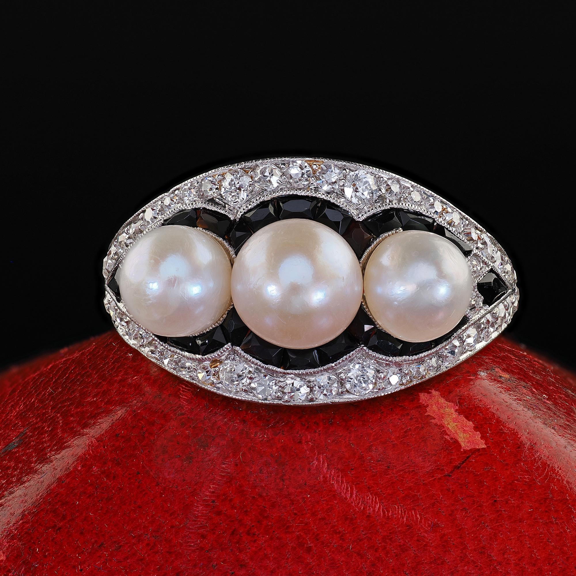 Beautiful Antique Art Deco Platinum Pearl Diamond and Onyx Three Stone Cocktail Ring. This gorgeous Art Deco pearl, diamond and onyx cocktail ring is crafted in platinum. This gorgeous ring features three beautiful pearls in the center of a gorgeous