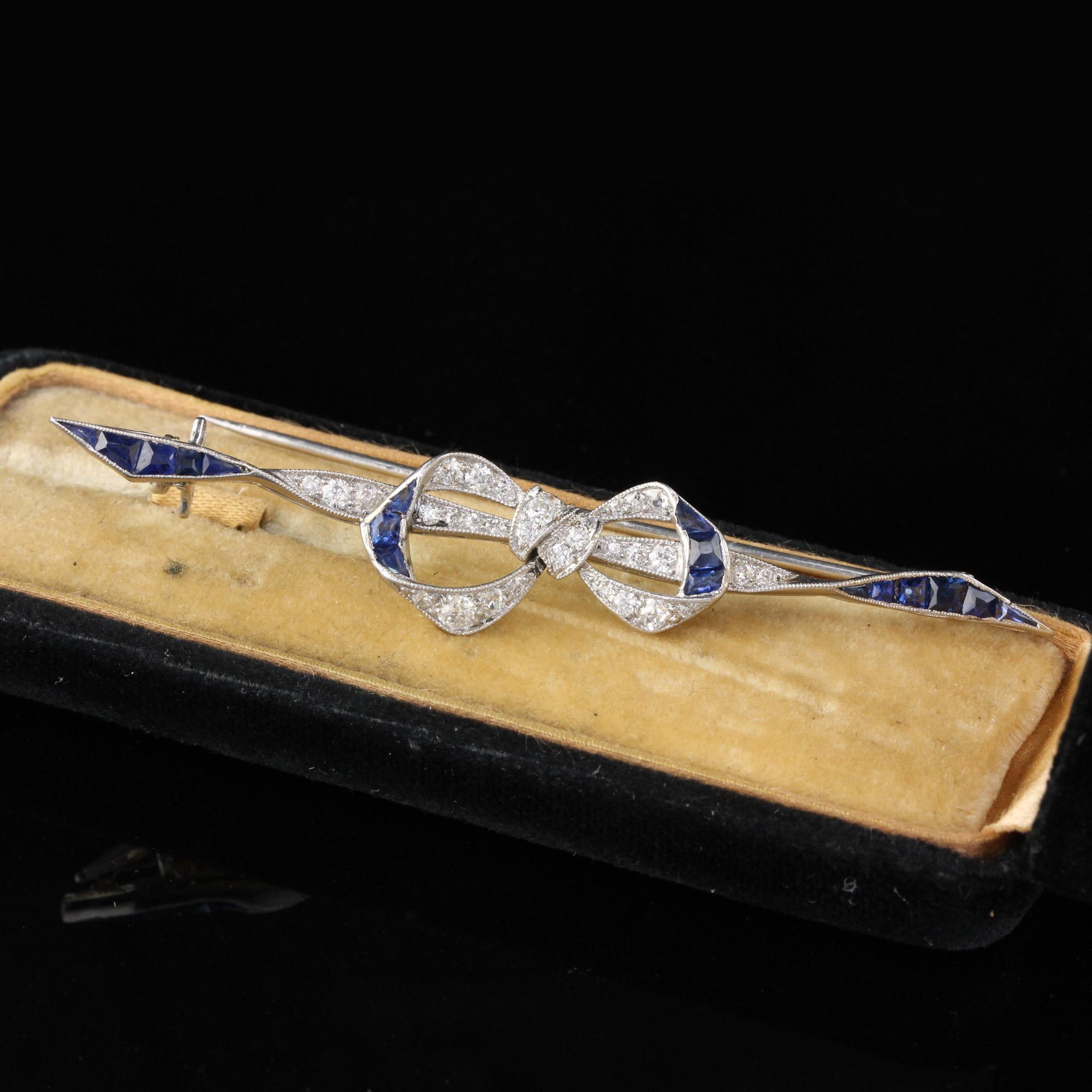 Stunning, bow-shaped diamond and sapphire pin.

Metal: Platinum (Tested by Kee tester which can test metal purity of all metals without scratching the item) 

Weight: 8.1 Grams

Diamond Weight: Approximately 0.50 ct

Diamond Color: H

Diamond