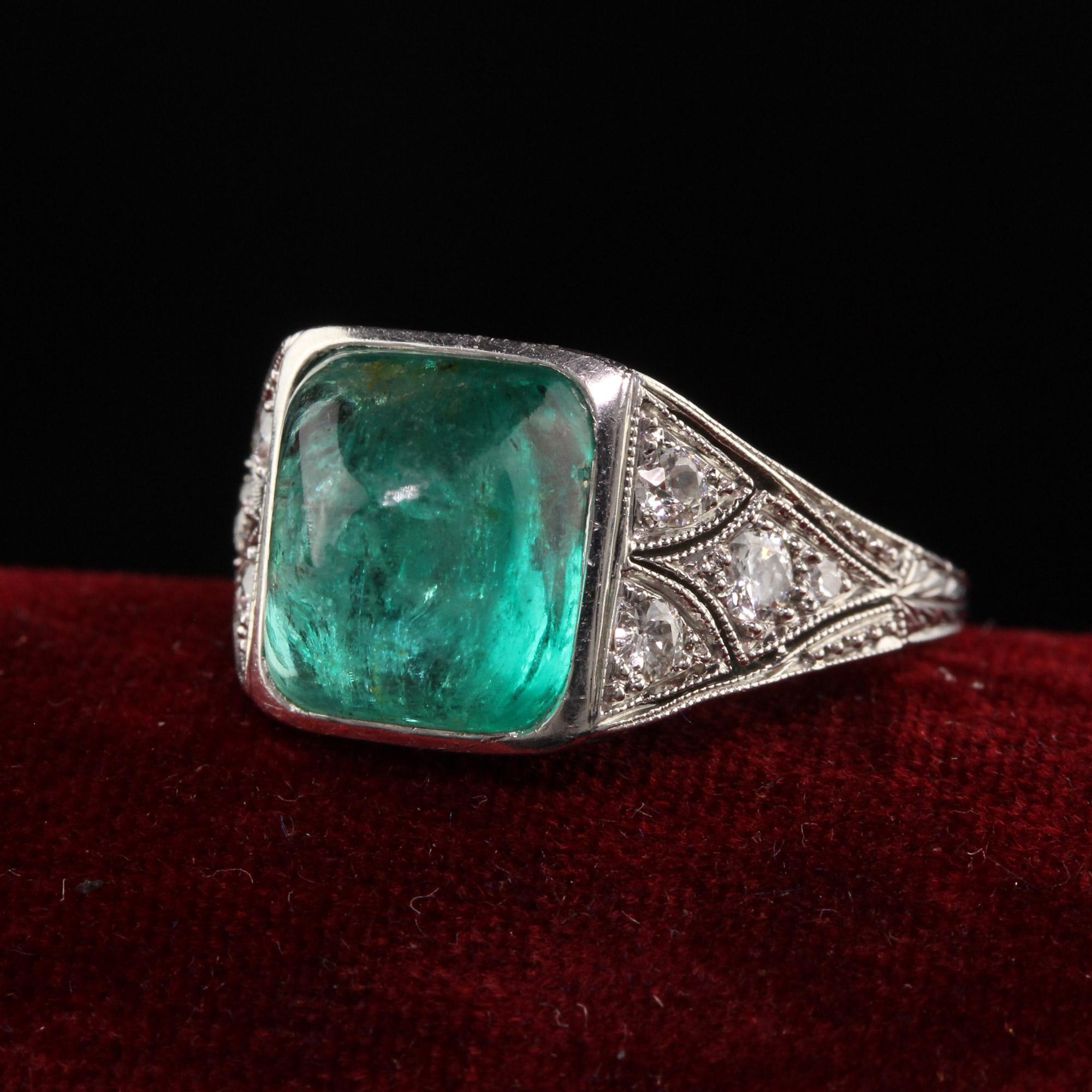Beautiful Antique Art Deco Platinum Sugar Loaf Emerald Old Euro Diamond Filigree Ring. This incredible Art Deco ring is crafted in platinum and has amazing filigree work on it. The center is a beautiful sugar loaf emerald that is bezel set in an