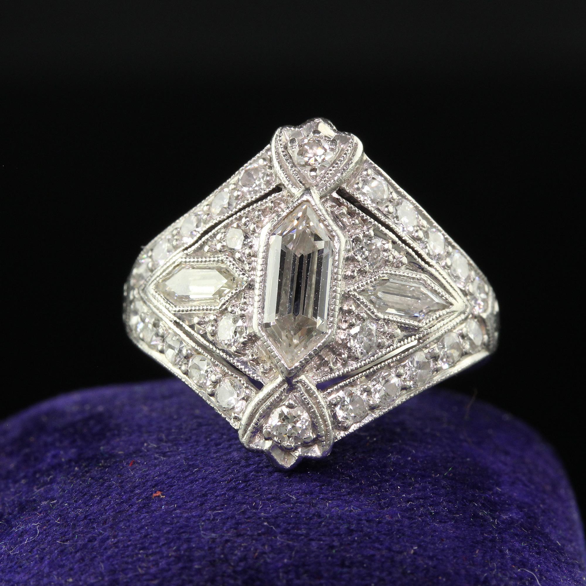 Beautiful Antique Art Deco Platinum Trapezoid Cut Diamond Cocktail Shield Ring. This incredible Art Deco cocktail shield ring is crafted in platinum. This ring features a gorgeous combination of old trapezoid cut diamonds and old European cut