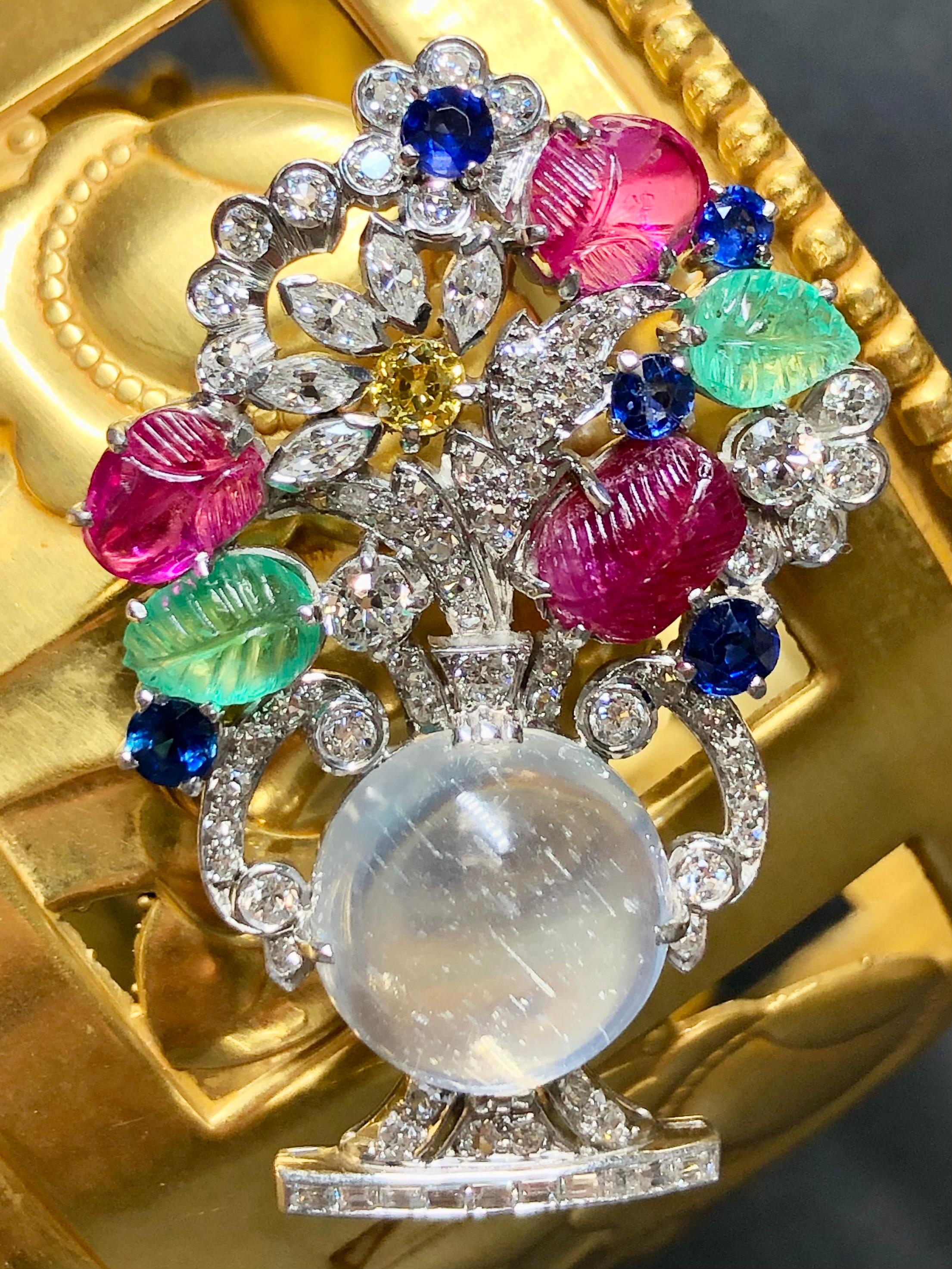 One of the most desirable styles from one of the most desirable eras in jewelry manufacturing. This “tutti frutti” flower pot brooch is hand crafted in platinum and set with marquise and old mine cut diamonds in both fancy yellow and white. It is