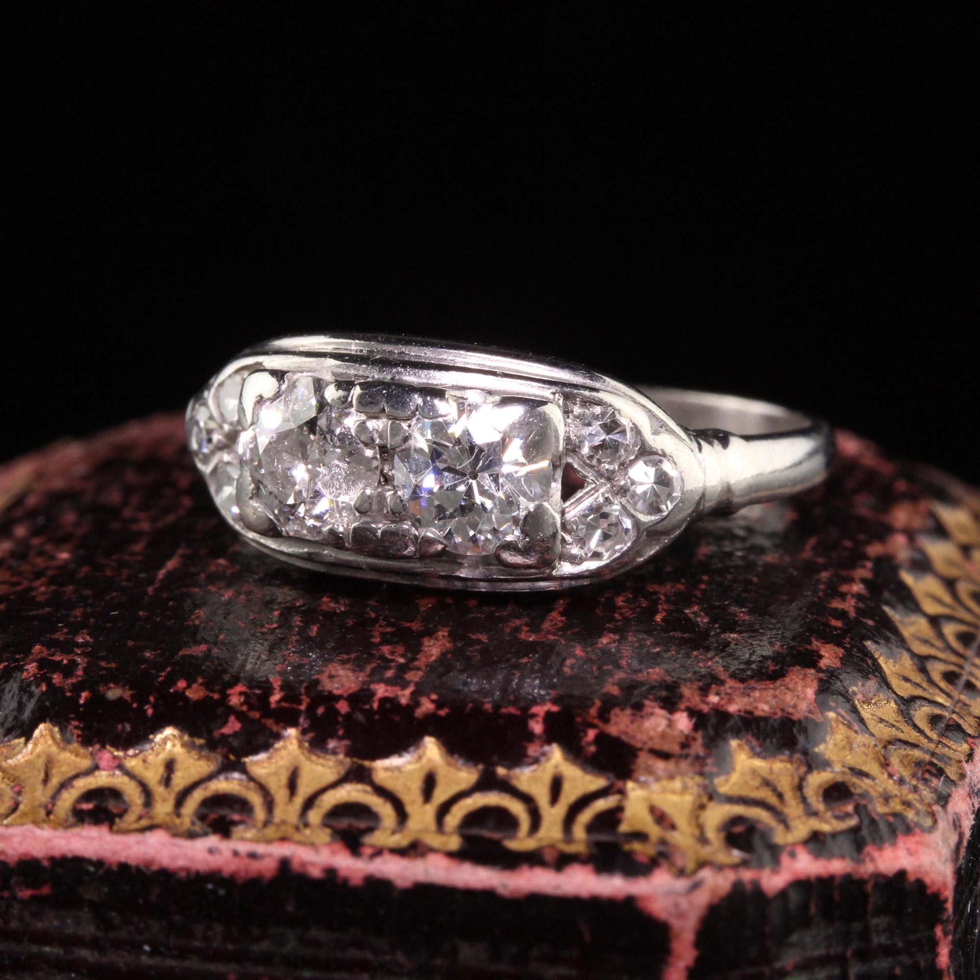 Beautiful Antique Art Deco Platinum Two Stone Old Mine Diamond Ring. This beautiful ring is crafted in platinum. The ring holds two old european cut diamonds with three single cut diamonds on each side. One of the larger diamonds is chipped but it