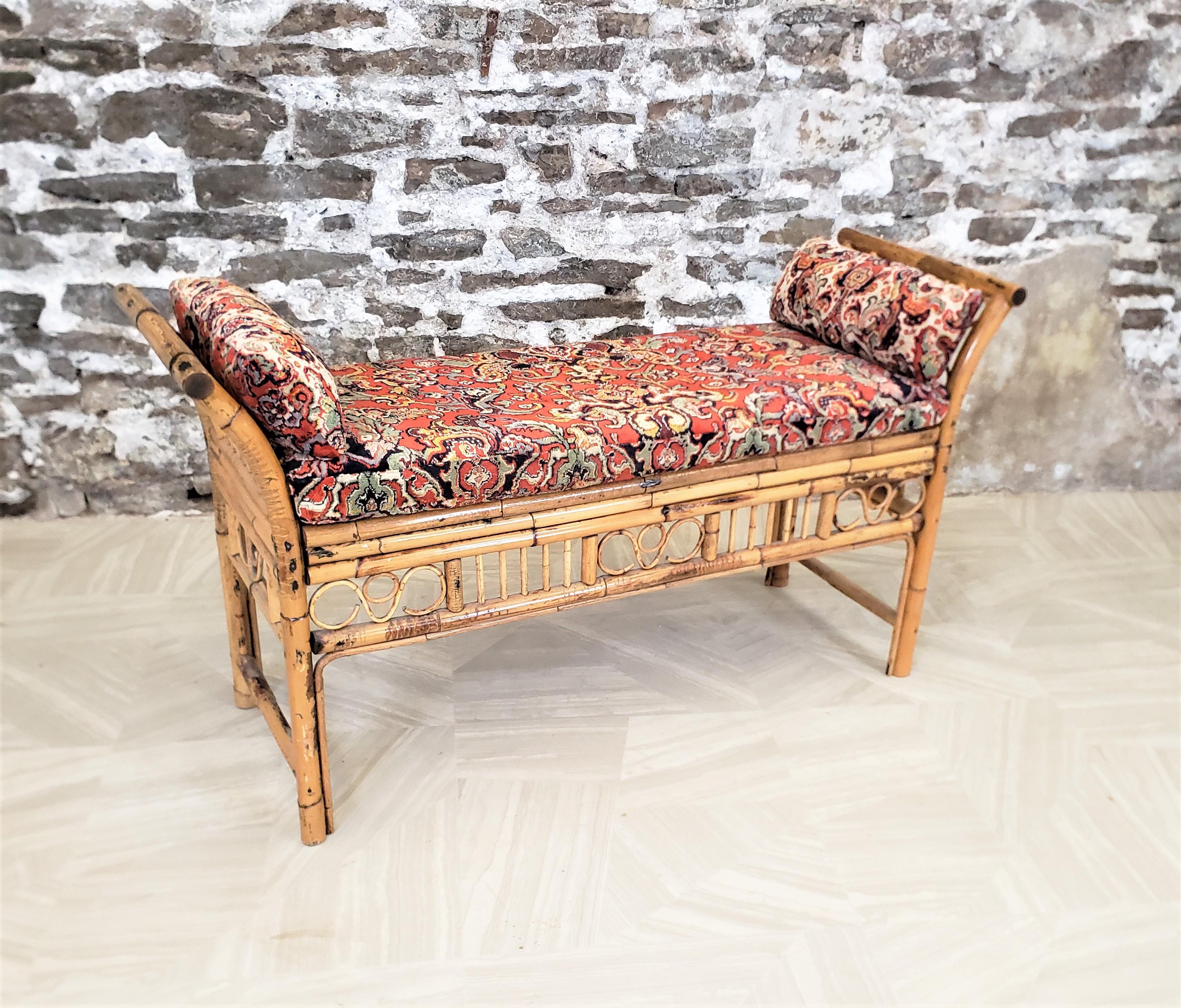 This antique bench is unsigned, but presumed to have originated from Italy and date to approximately 1920 and done in the period Boho style. The bench is composed of rattan with a caned seat. The sides and both front and back are accented with a