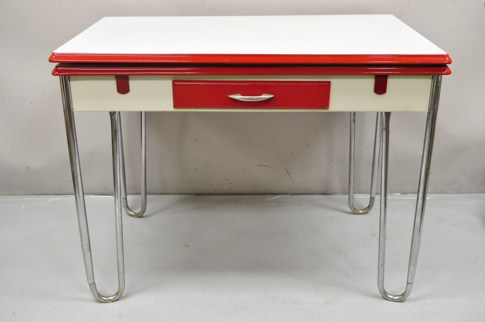 Antique Art Deco Red and White Porcelain Enamel 40” Extension Kitchen Table. Item features pullout extension leaves, one drawer, tubular legs, very nice antique item. Circa Early 20th Century. Measurements: 30.5