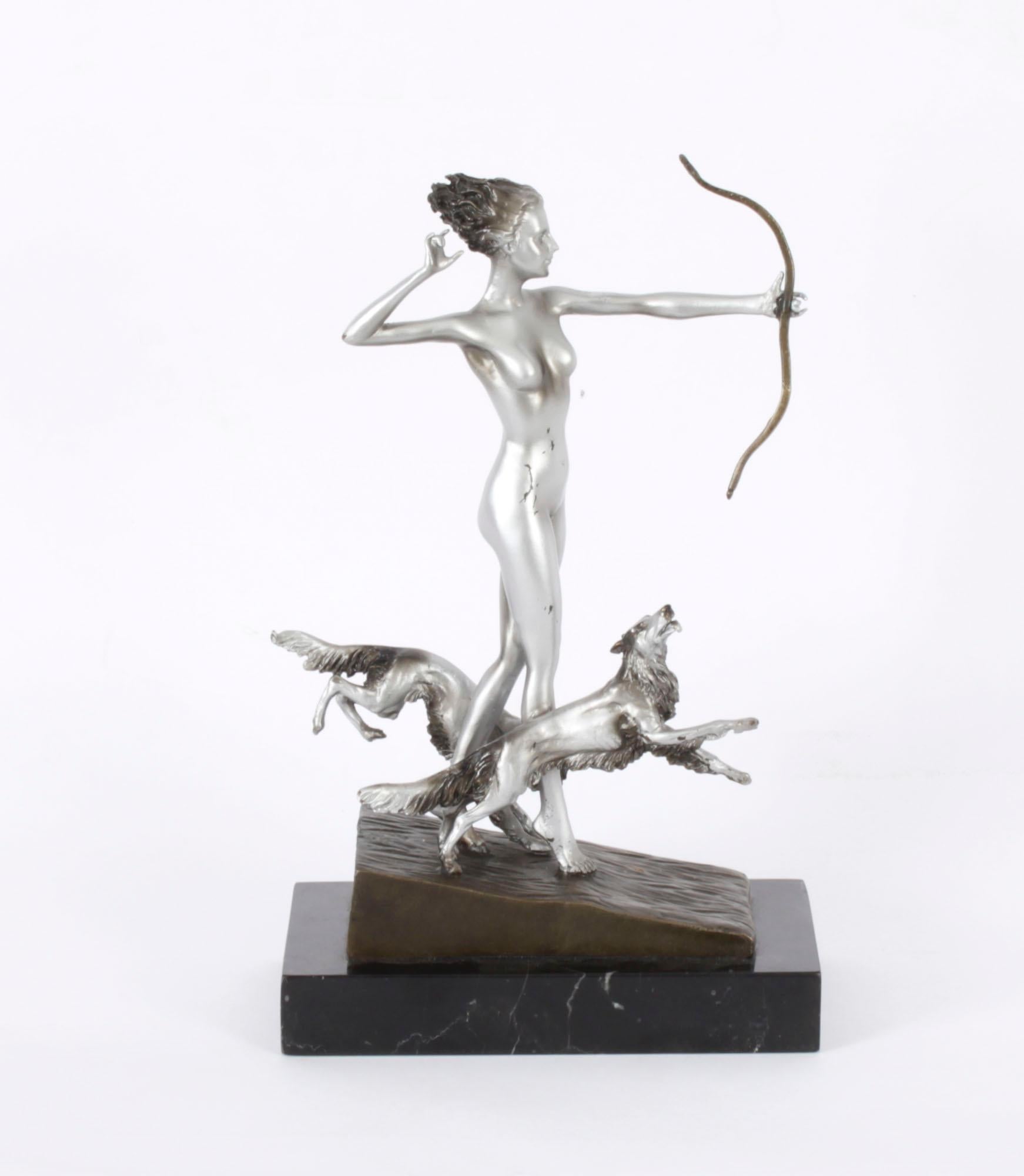A beautiful Art Deco Revival sculpture of Diana the Huntress with Hounds, after Josef Lorenzl, dating from the 20th Century.

The decorative sculpture of silvered cast-bronze features a naked Diana the Huntress, with bow and a pair of hunting dogs,