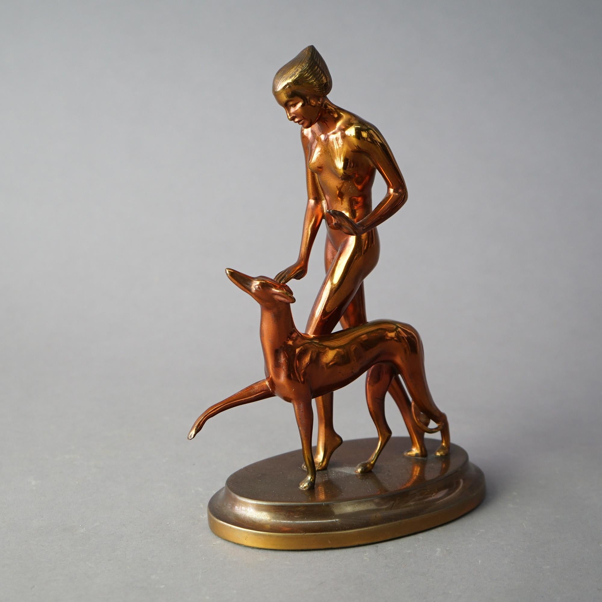 An antique Art Deco Ronson Georgian grouping offers gold metal construction and depicts a nude woman and her dog (Whippet), circa 1920

Measures - 11.25