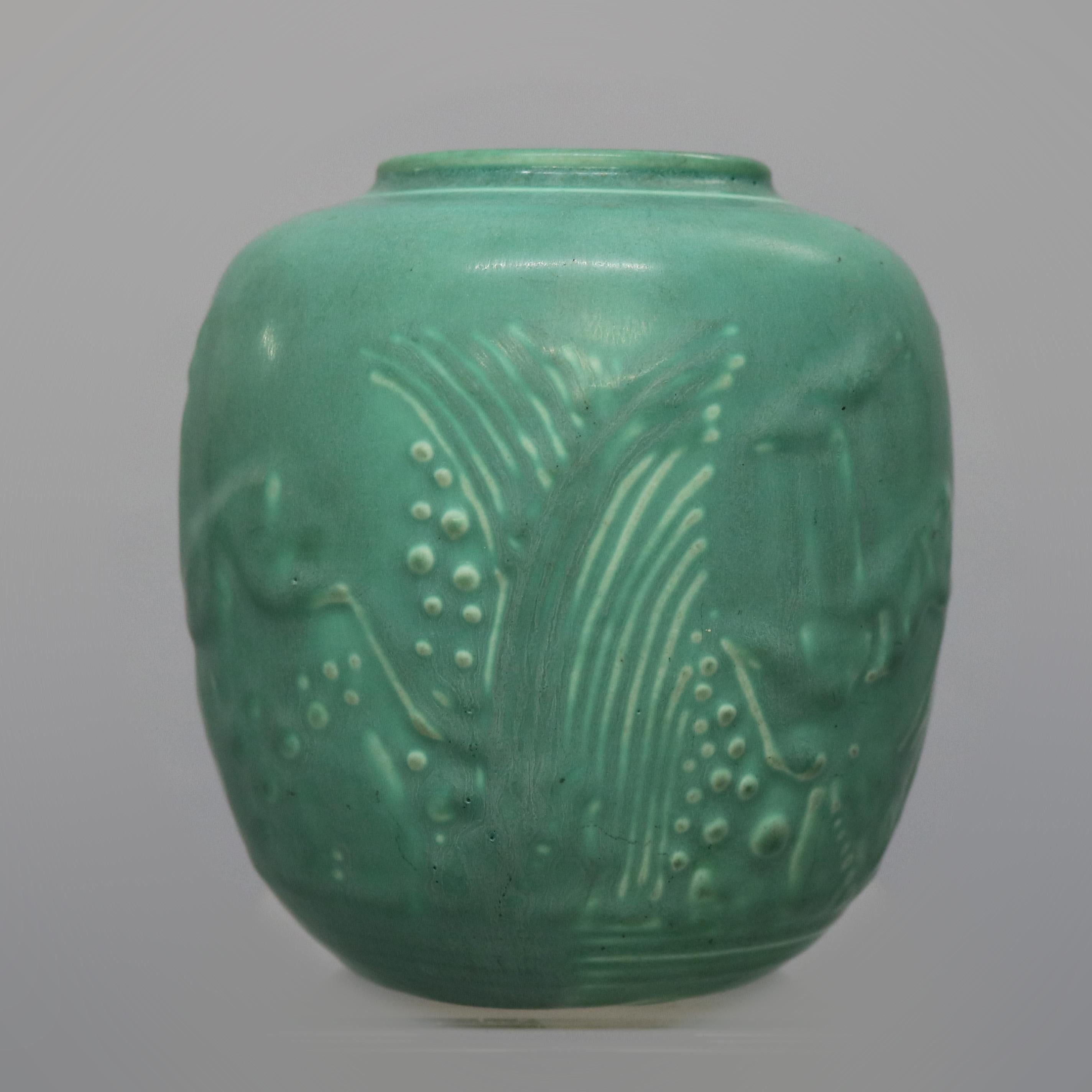 An antique Art Deco Vase by Rookwood offers art pottery with stylized landscape scene with leaping deer, signed on base as photographed, dated 1932

Measures: 4.5