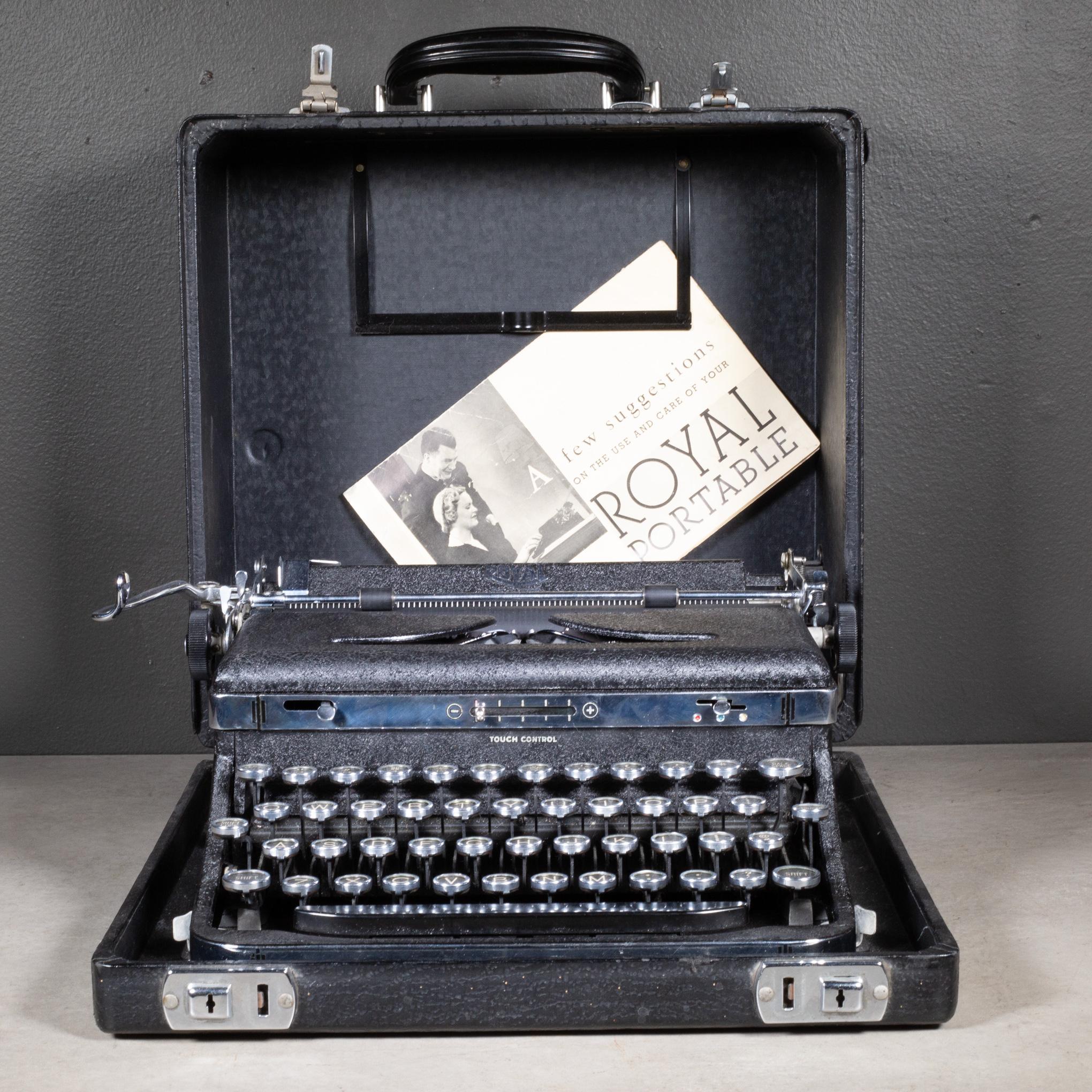 ABOUT

An antique Art Deco Royal De Luxe typewriter in crinkle black finish with two nickel bands at the top and bottom and gull wings. Original manual and wooden cleaning brush. Glass keys with black and gold lettering. Original leather case with