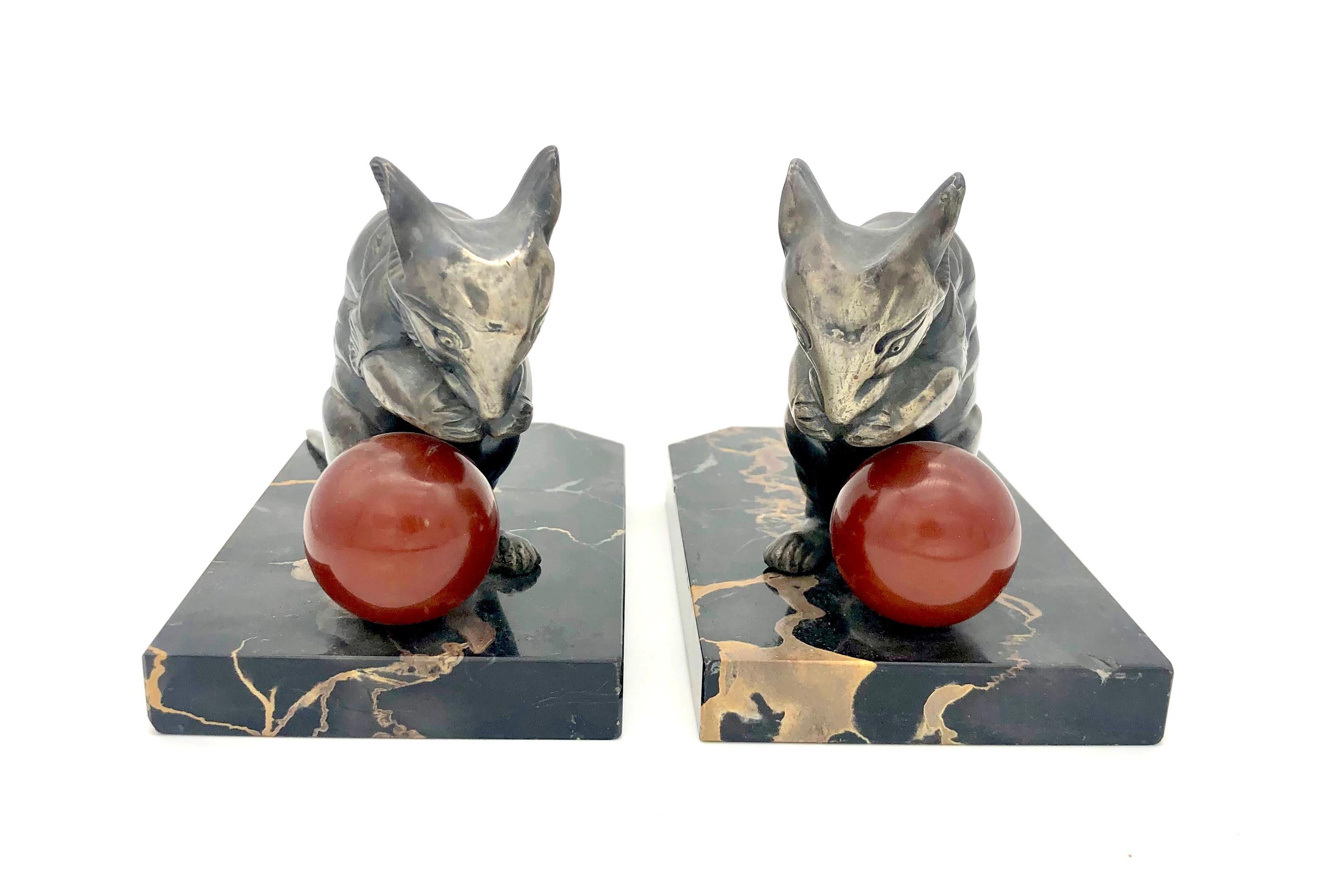 The two beautiful mice have been cast out of spelter and silver plated. The little creatures are playing with a deep red ball made out of bakelite.  Mice and balls are mounted on marble bases. On of the pieces of marble has a small chip.  The mice