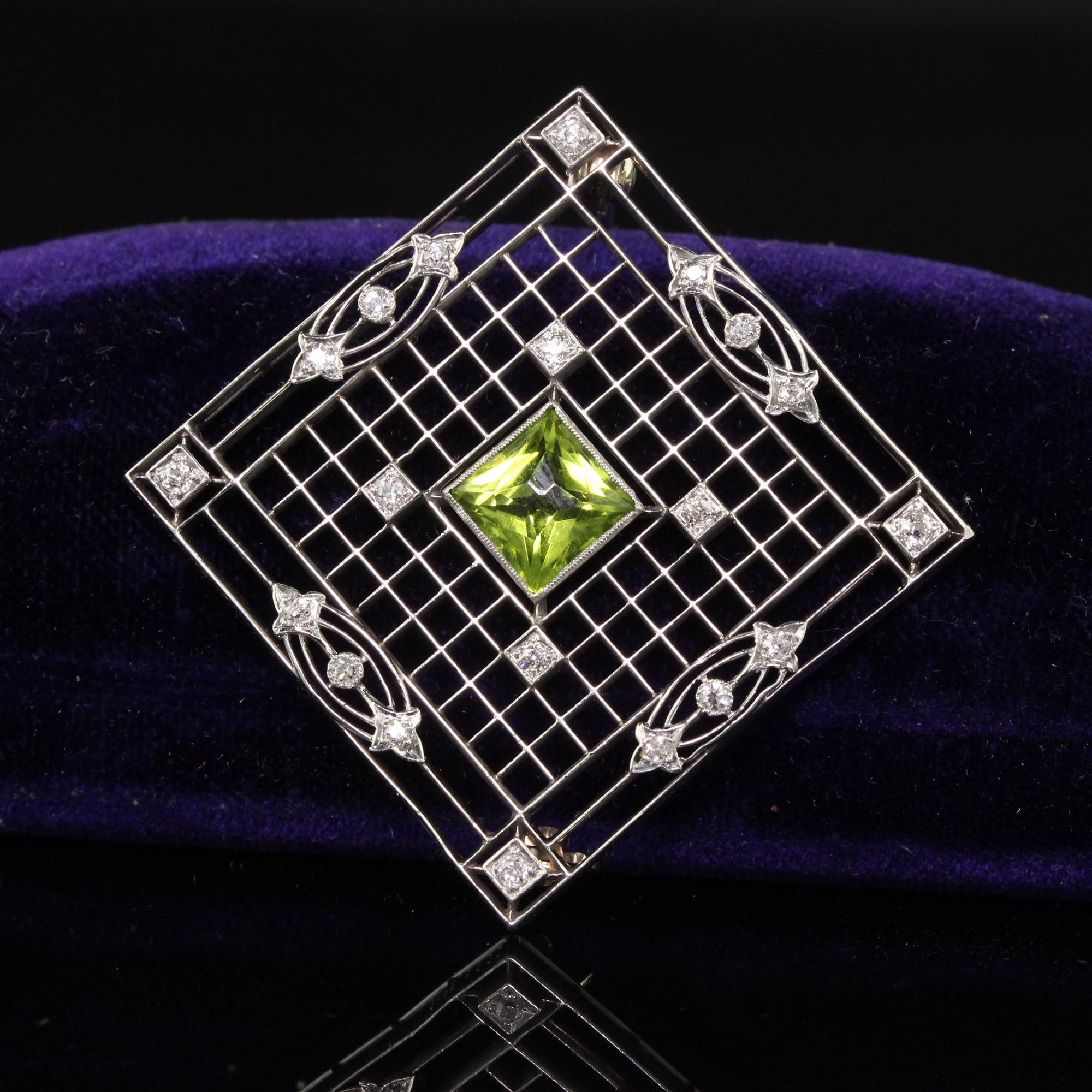Beautiful Antique Art Deco Shreve and Co Platinum French Cut Peridot Diamond Filigree Pin. This incredible Shreve and Co pin is crafted in platinum. The center holds a gorgeous French cut peridot and has old cut diamonds set in filigree stations