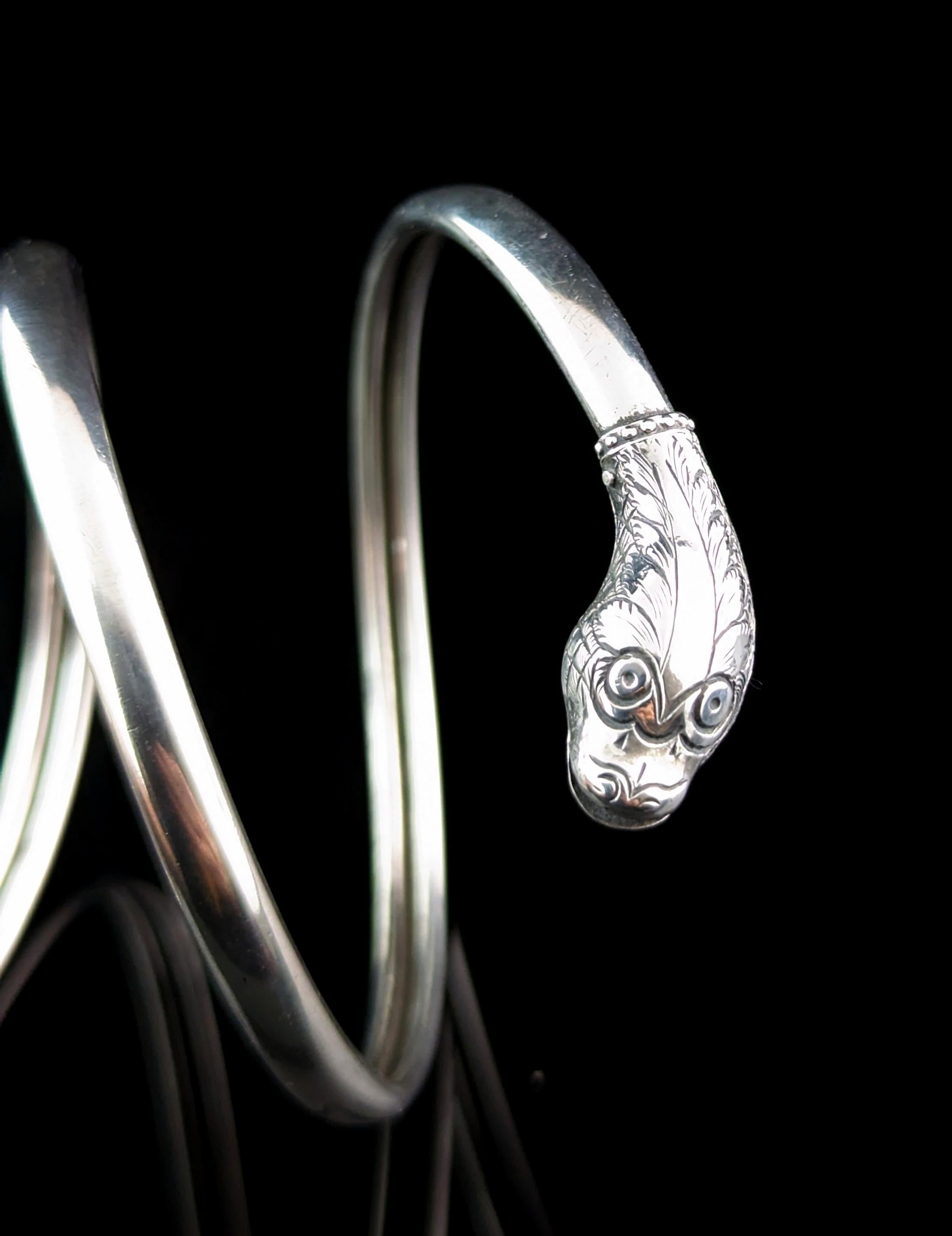 Whoever takes home this amazing antique sterling silver snake bangle will not be disappointed!

This spectacular piece is an arm bangle and made at the height of the Art Deco Egyptian revival period and this is one period that saw arm bangles rise